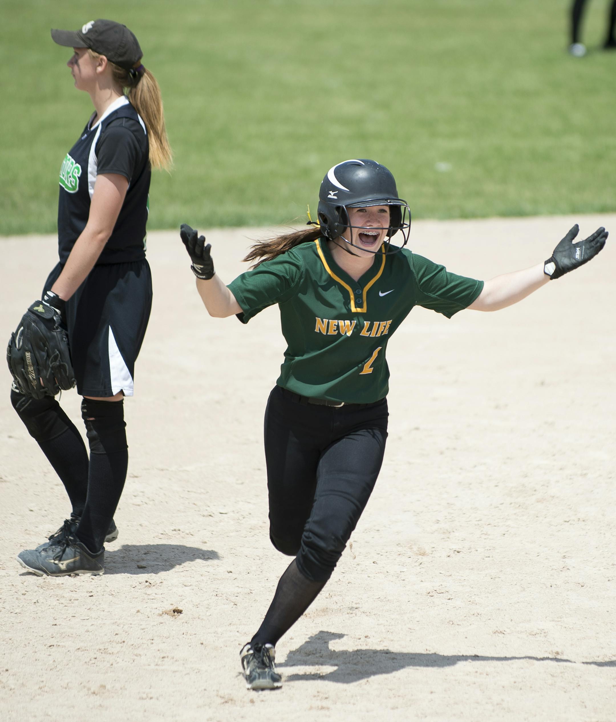 New Life Academy of Woodbury second baseman Elena Linster (2) gestured to her teammates as she rounded the bases after hitting her second homer Friday during her team's 1A championship game against Badger/Greenbush- Middle River. ] Aaron Lavinsky • aaron.lavinsky@startribune.com The softball state tournament finals were held Friday, June 5, 2015 at Caswell Park in Mankato.