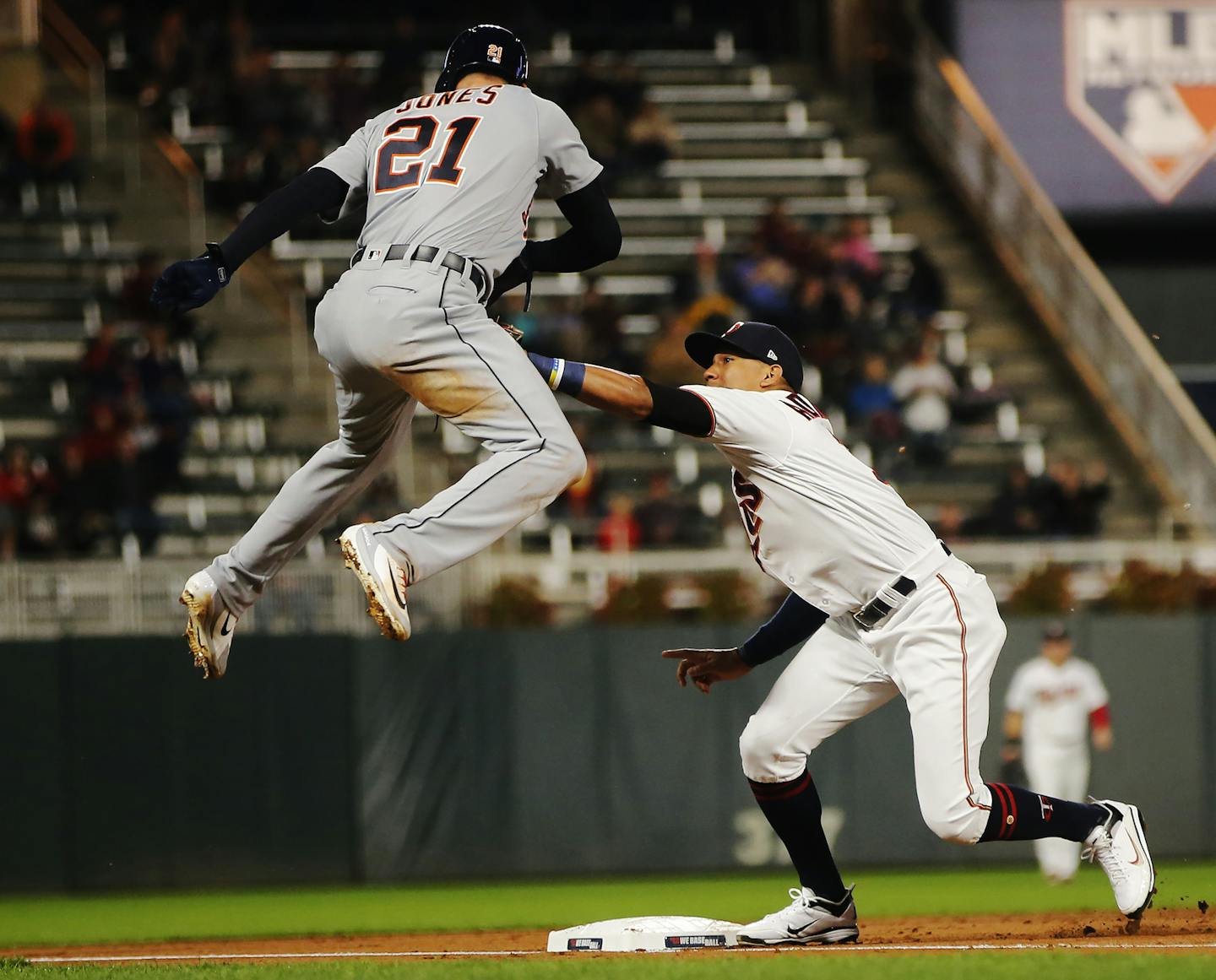 The Minnesota Twins' Ehire Adrianza tags out the Detroit Tigers' JaCoby Jones (21) at third base in the third inning at Target Field in Minneapolis on Tuesday, Sept. 25, 2018. (Richard Tsong-Taatarii/Minneapolis Star Tribune/TNS)