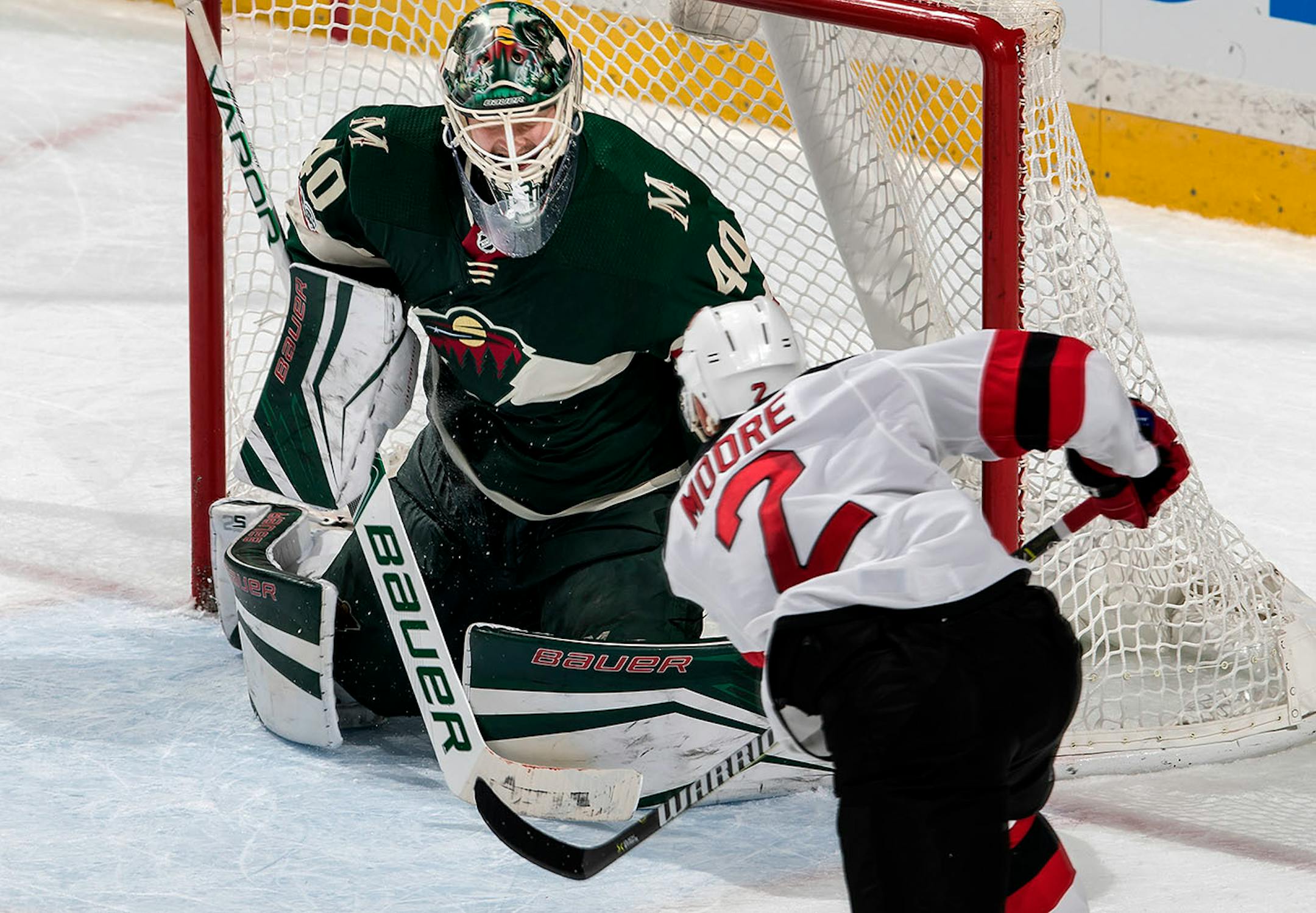 John Moore (2) shot the puck past Wild goalie Devan Dubnyk (40) to win the game in overtime.