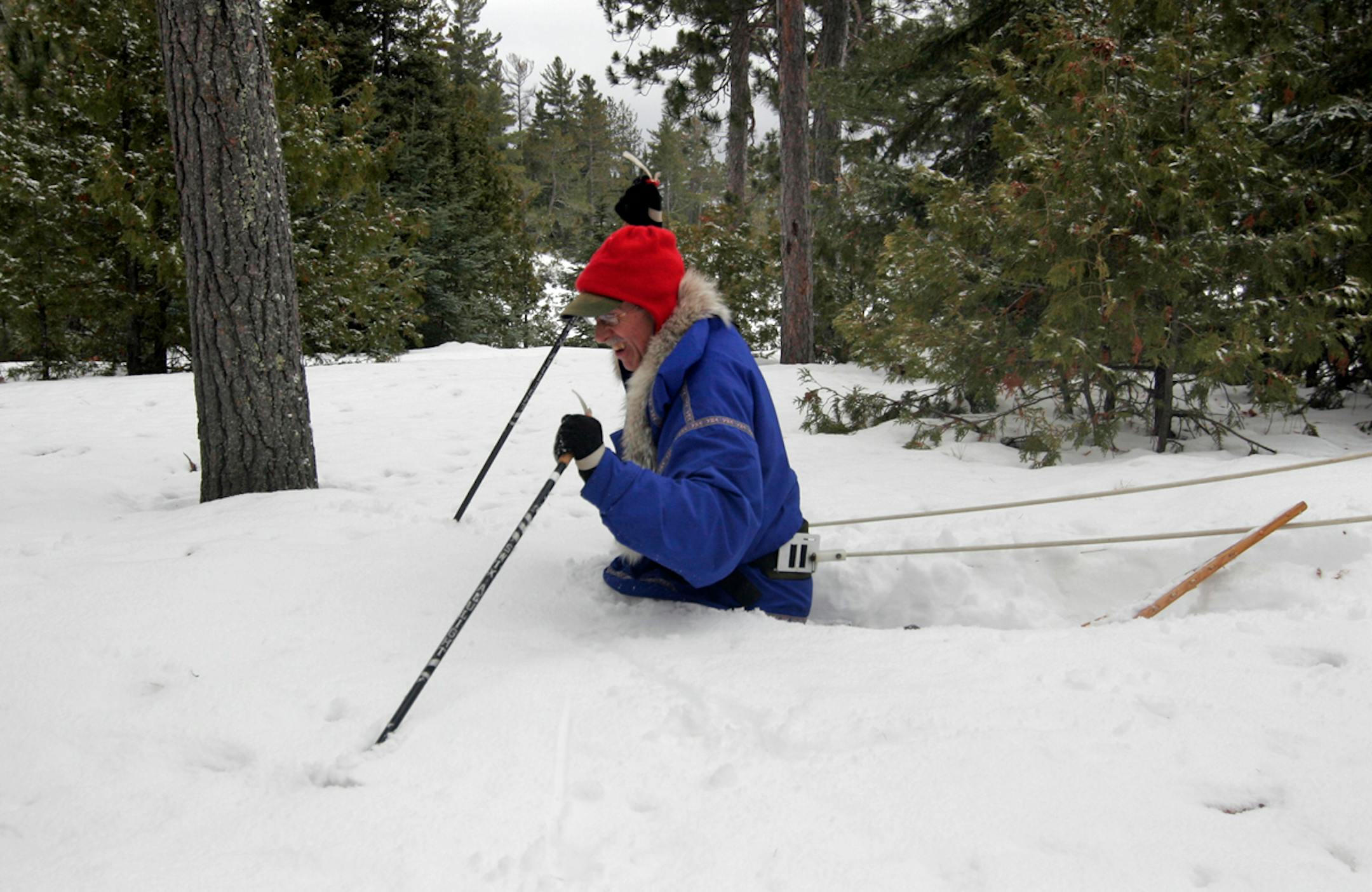 Despite wearing snowshoes, Sam Cook of Duluth is swallowed by deep snow at a BWCA campsite during a three-day camping trip near Ely last weekend. Photo by Doug Smith/Star Tribune.