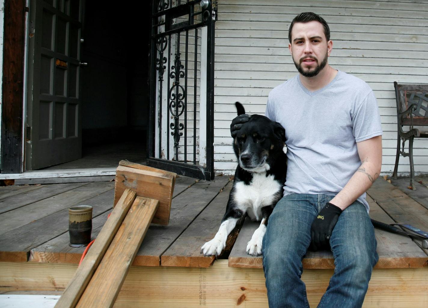 Drew Philp on the porch of his dilapidated Queen Anne in Detroit's inner city.
Photo by Garrett MacLean