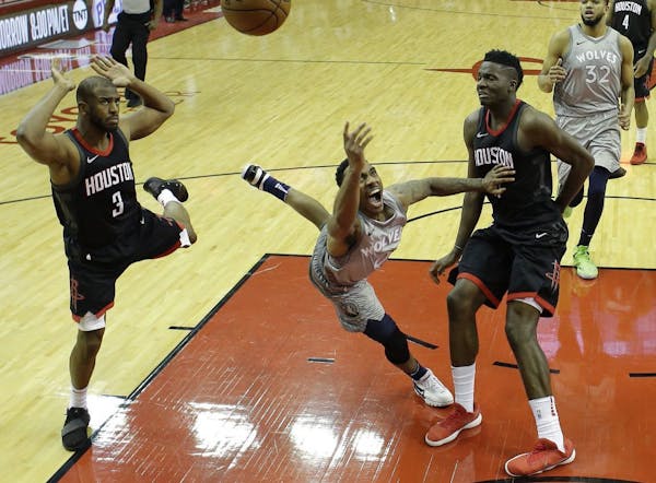 Jeff Teague shoots between the Rockets' Chris Paul, left, and Clint Capela during the second half in Game 1