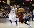 Cleveland Cavaliers' Kyrie Irving (2) drives against Minnesota Timberwolves' Ricky Rubio (9), from Spain, in the first half of an NBA basketball game,