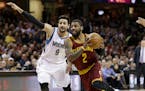 Cleveland Cavaliers' Kyrie Irving (2) drives against Minnesota Timberwolves' Ricky Rubio (9), from Spain, in the first half of an NBA basketball game,