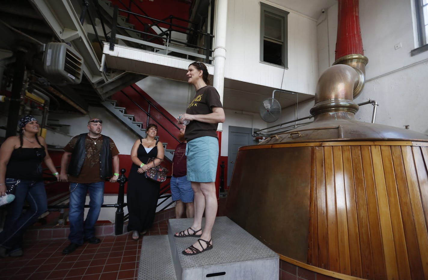 In New Ulm at the August Schell Brewery, tour guide Claire Bunda explained how a beer is born. She is standing next to a copper vat that is only used for heating water for the brewing process. The actual rewing is done in modern vats. "Our brewery is really different. There are so many different things to enjoy," said Bunda. She pointed out the museum, gardens as well as the peacocks that roam the grounds.] rtsong-taatarii@startribune.com