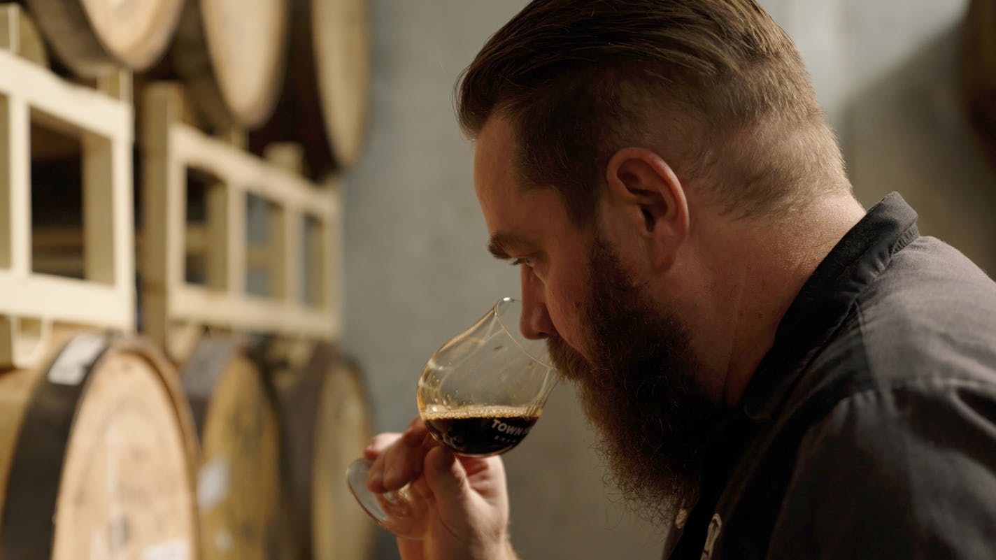 Provided: Mike Hoops, head brewer at Town Hall Brewery, samples barrel-aged beer.