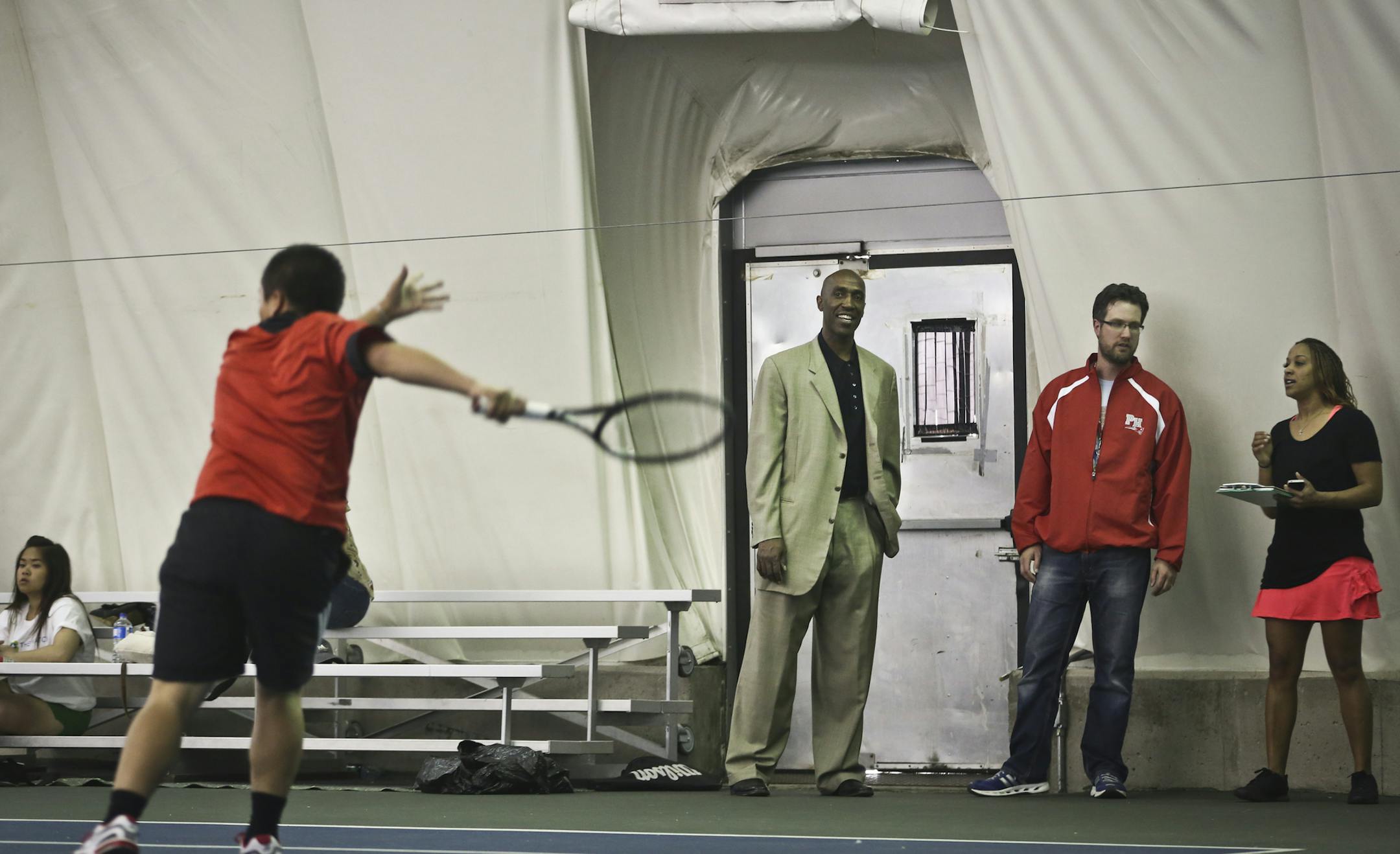 Minneapolis Public Schools Athletic Director Trent Tucker, in suit, who is also a former NBA and Gopher player, watched a match between Patrick Henry and North Minneapolis while standing with the head coaches Paul Czarnezki and Nancy Akpan at the Reed-Sweatt Family Tennis Center in Minneapolis, Minn. on Monday, May 6, 2013. ] (RENEE JONES SCHNEIDER * reneejones@startribune.com) Paul Czarnezki CQ and Nancy Akpan CQ