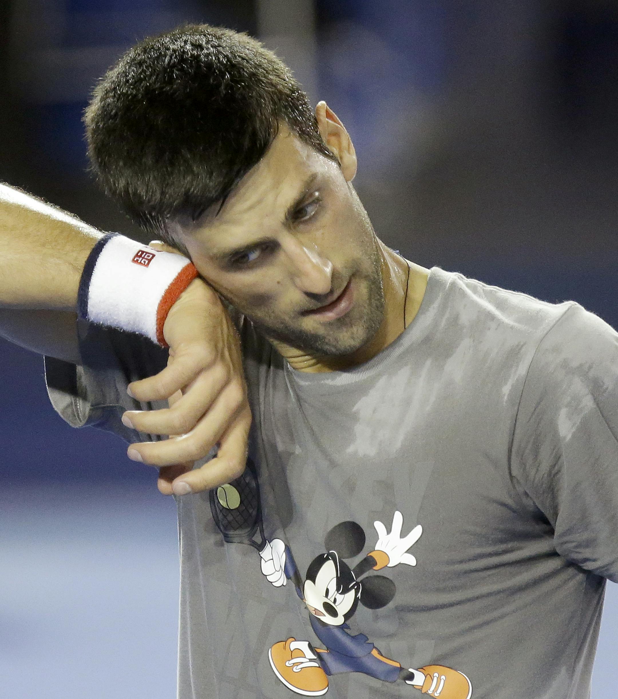 Serbia's Novak Djokovic wipes sweat from his face during training session on Rod Laver Arena ahead of the Australian Open tennis championships in Melbourne, Australia, Thursday, Jan. 14, 2016.(AP Photo/Mark Baker)