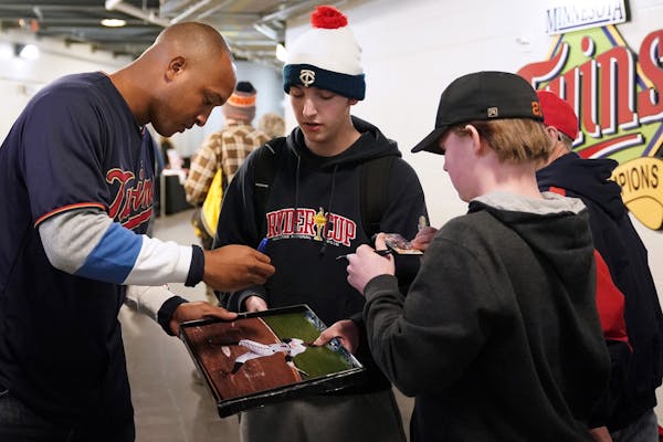 Twins' new second baseman Jonathan Schoop stopped in the hallway to sign autographs for a group of fans.