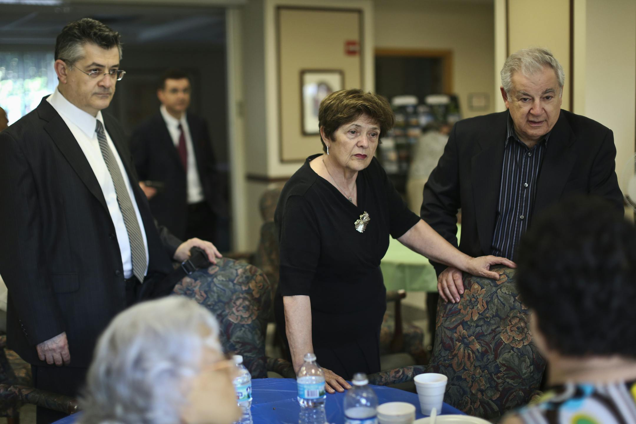Family of 101-year-old Roza Sakhina who was killed earlier this week after being backed into by a police officer, chatted with guests at a get together after her funeral at her apartment complex on Friday, August 23, 2013, in St. Paul, Minn. From the left; Lenny Finkelshteyn (grandson), Ilya Finkelshteyn (grandson in far background), Raisa Finkelshtzen (daughter-in-law) and Mark Finkelshteyn (son). ] (RENEE JONES SCHNEIDER ‚Ä¢ reneejones@startribune.com)