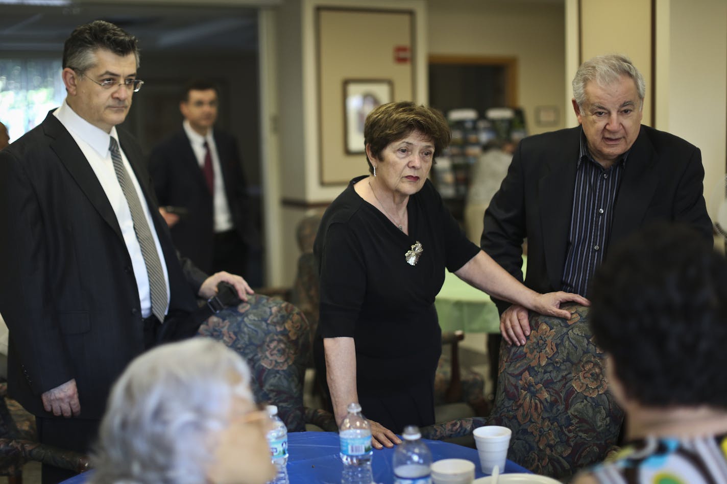 Family of 101-year-old Roza Sakhina who was killed earlier this week after being backed into by a police officer, chatted with guests at a get together after her funeral at her apartment complex on Friday, August 23, 2013, in St. Paul, Minn. From the left; Lenny Finkelshteyn (grandson), Ilya Finkelshteyn (grandson in far background), Raisa Finkelshtzen (daughter-in-law) and Mark Finkelshteyn (son). ] (RENEE JONES SCHNEIDER &#x201a;&#xc4;&#xa2; reneejones@startribune.com)