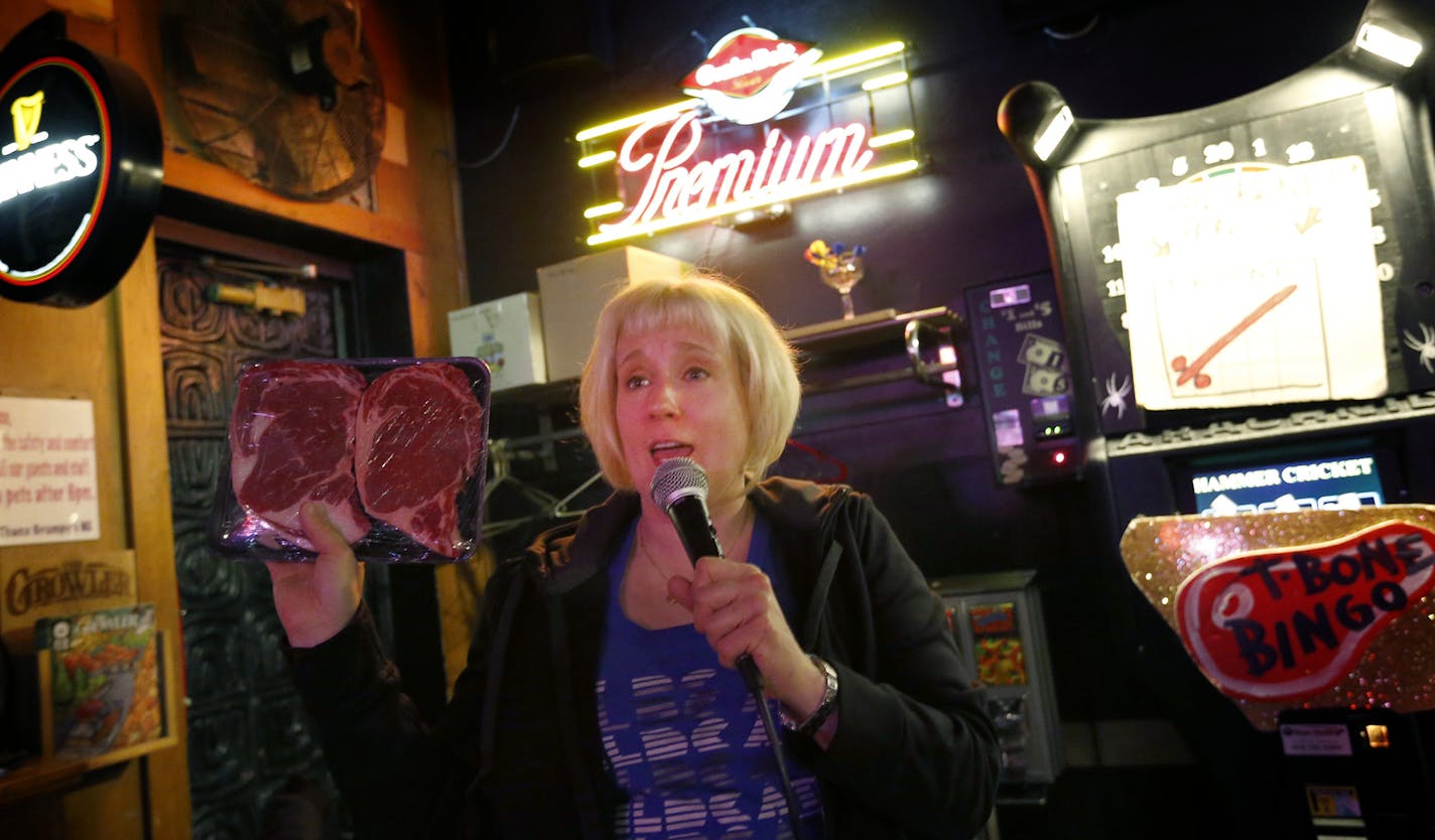 Johnna Lush held up a prize during a game of T-Bone Bingo at Grumpy's Bar in Northeast Minneapolis. ] CARLOS GONZALEZ cgonzalez@startribune.com, March 1, 2015, Minneapolis, Minn., Minnesota's most unusual dive-bar traditions: meat raffles