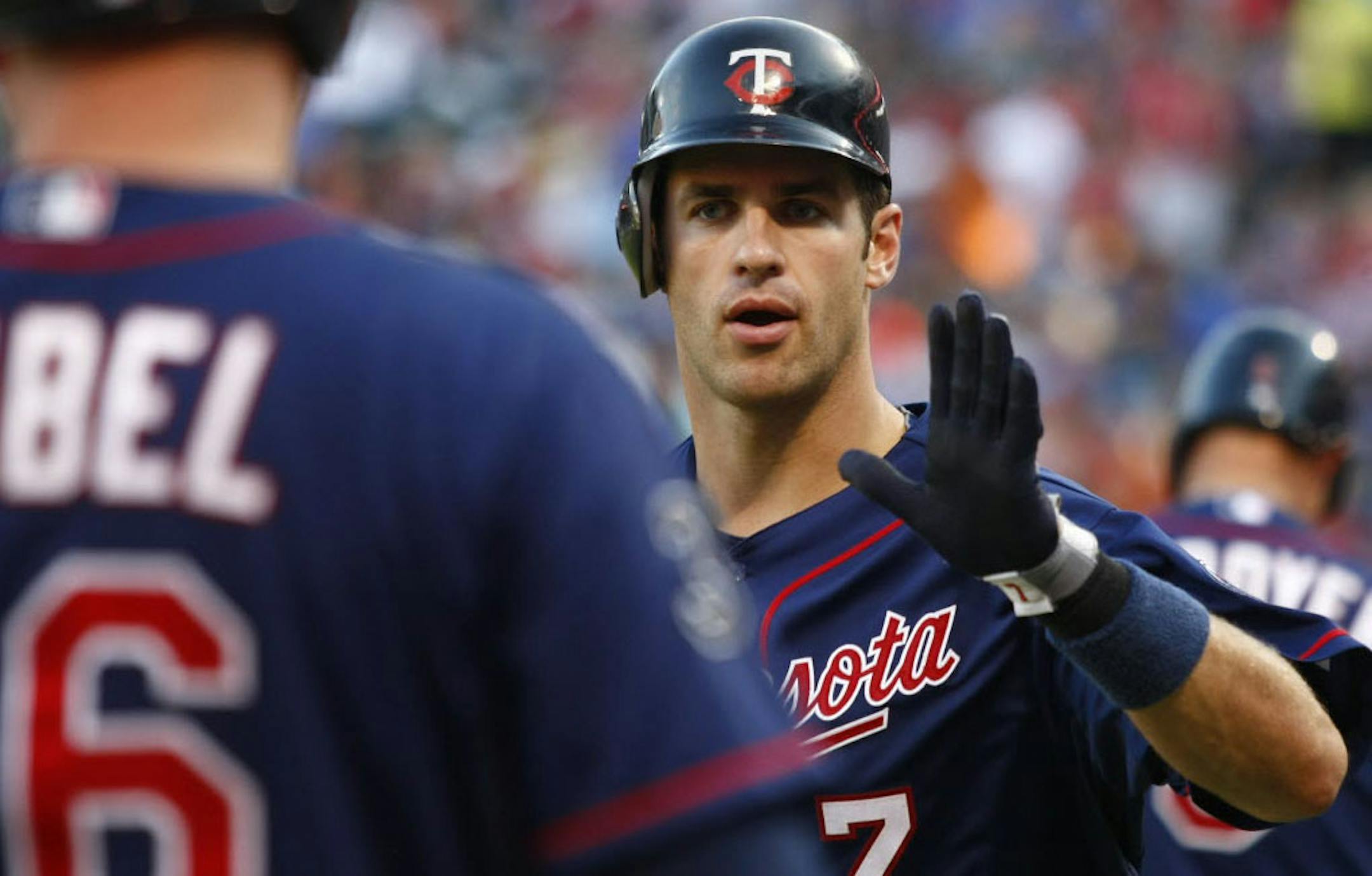 Joe Mauer (7) celebrates his solo homer against the Texas Rangers during the first inning.