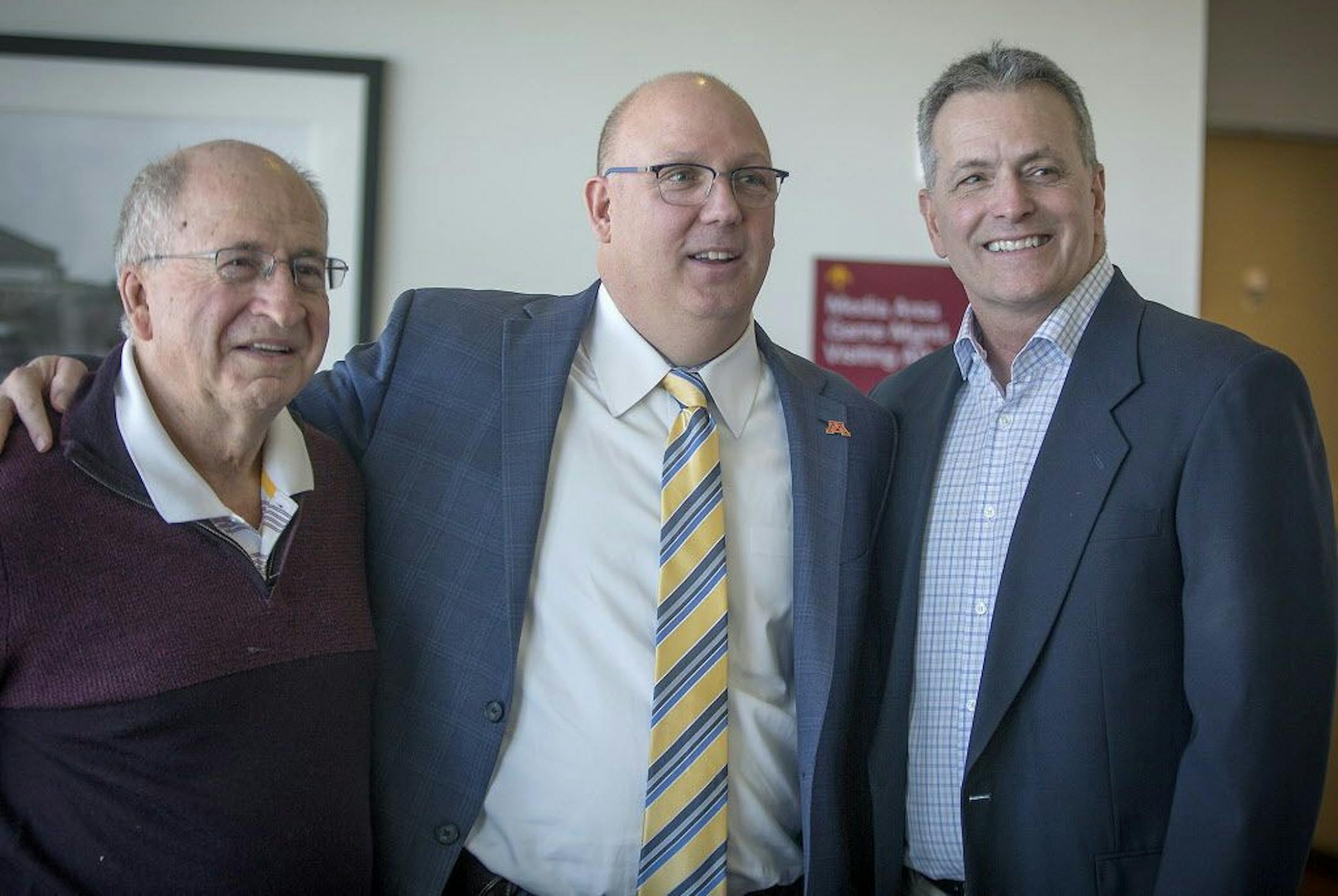 Bob Motzko, the new Gophers hockey coach, center, was given some pointers from former hockey head coaches including Doug Woog, left, and Don Lucia, right, after a press conference at TCF Bank Stadium, Thursday, March 29, 2018 in Minneapolis, MN.
