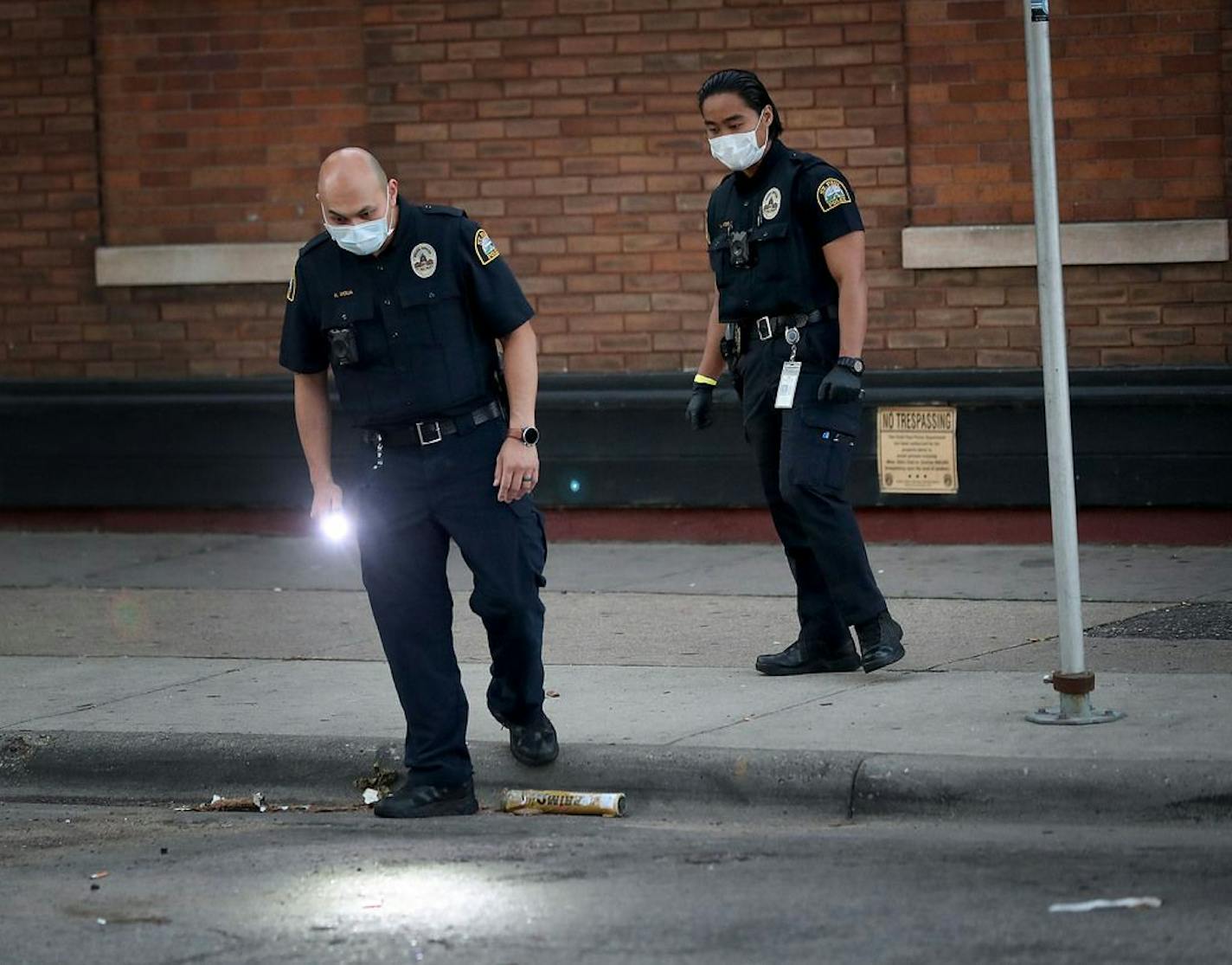 St. Paul law enforcement officers investigate the scene where a woman was shot in the early morning outside the Trend Lounge and later died at Regions Hospital Wednesday in St. Paul.