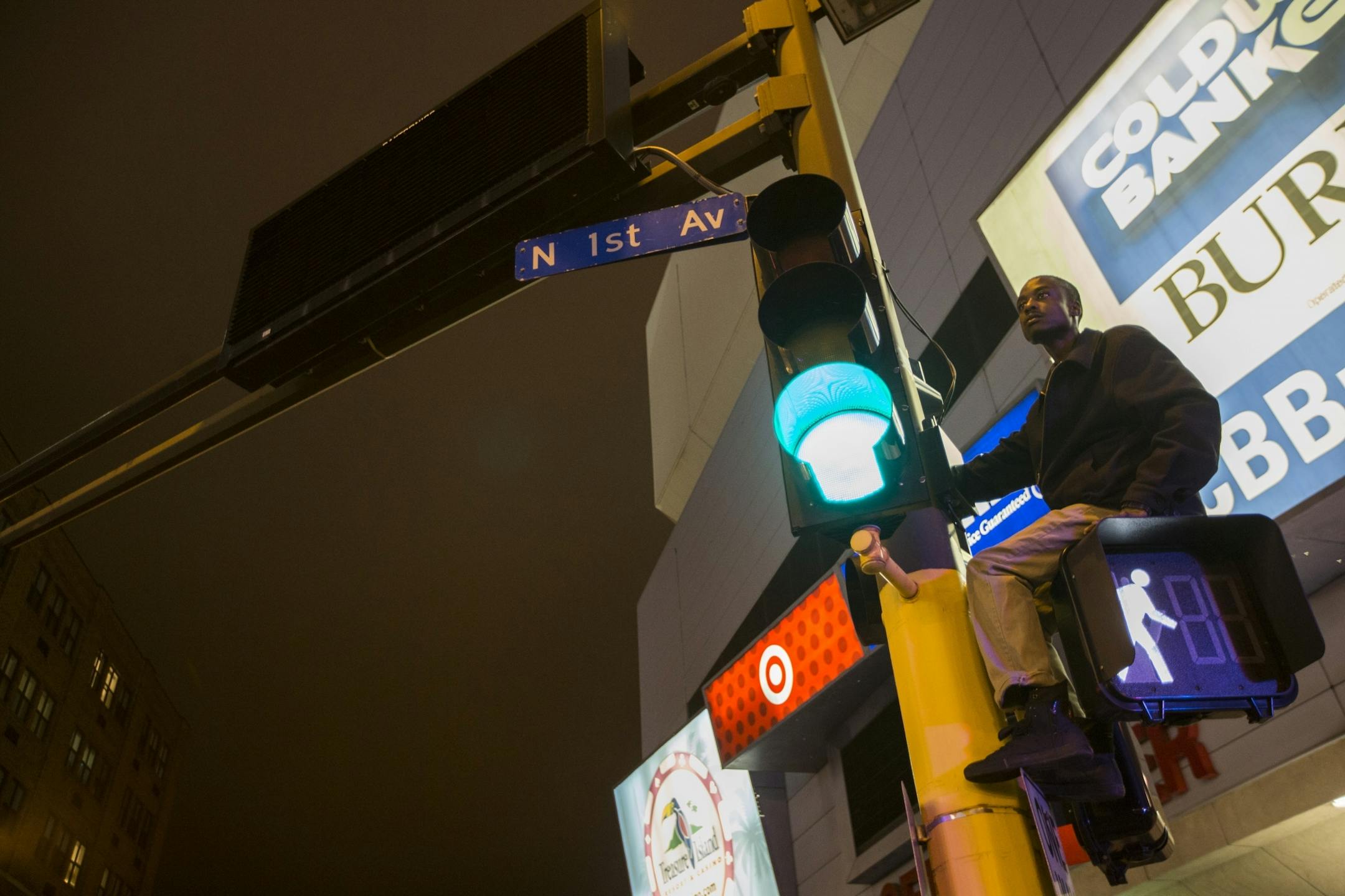 A man climbed a traffic light to get a view of what was happening at a Prince dance party outside of First Avenue on Thursday night, April 21, 2016.