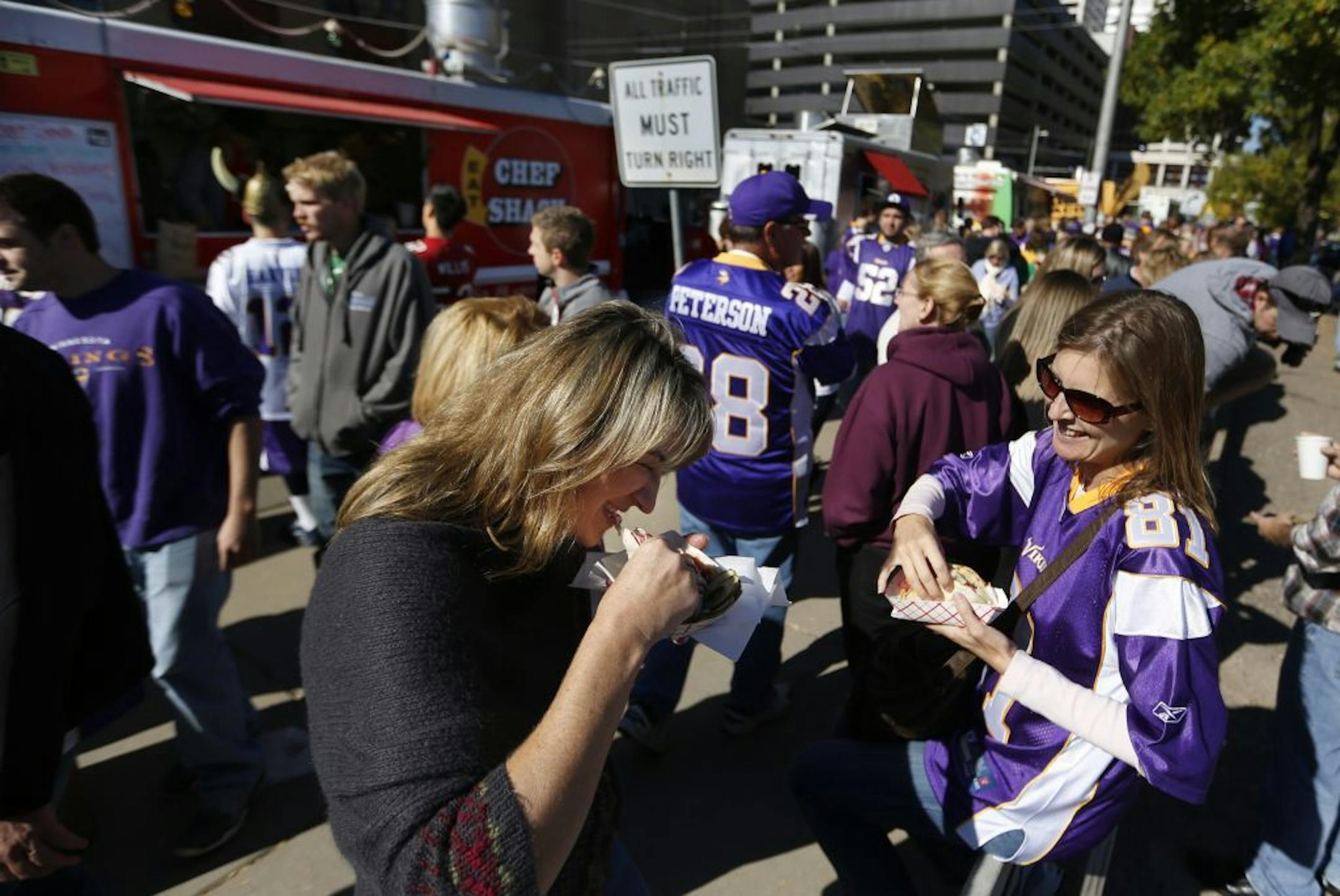 On Fifth Ave S., or the "Purple Path," designated for "railgating" on Vikings game day, friends Joclyn Goldade and Michelle Corbin enjoyed some tacos.