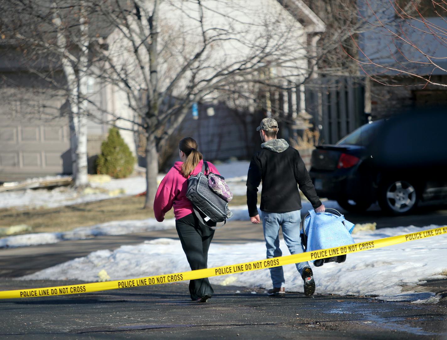 A family returns to their home in the aftermath of a food truck explosion in Lakeville that happened late Friday night and was seen in the 16500 block of Joplin Path Saturday, March 7, 2015, in Lakeville, MN](DAVID JOLES/STARTRIBUNE)djoles@startribune.com Police responded to the scene on the 16500 block of Joplin Path around 11:30 p.m. after a loud boom erupted on the block. Photos posted on social media by neighbors show scraps of metal strewn across yards and driveway and some damage to nearby