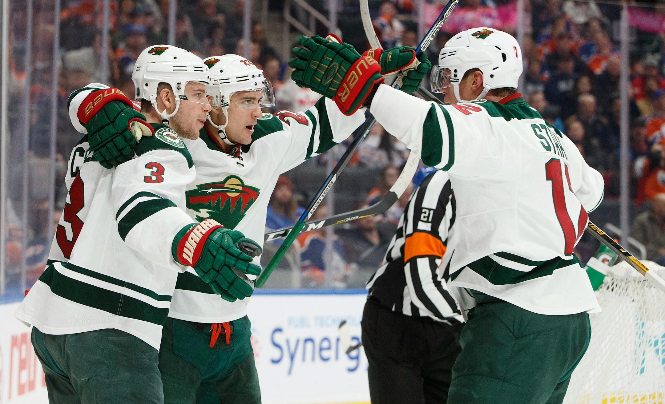 Minnesota Wild's Charlie Coyle (3), Nino Niederreiter (22) and Eric Staal (12) celebrate a goal against the Edmonton Oilers during the first period of an NHL hockey game in Edmonton, Alberta, Sunday, Dec. 4, 2016. (Jason Franson/The Canadian Press via AP)