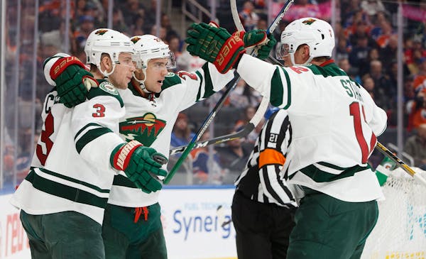 Minnesota Wild's Charlie Coyle (3), Nino Niederreiter (22) and Eric Staal (12) celebrate a goal against the Edmonton Oilers during the first period of