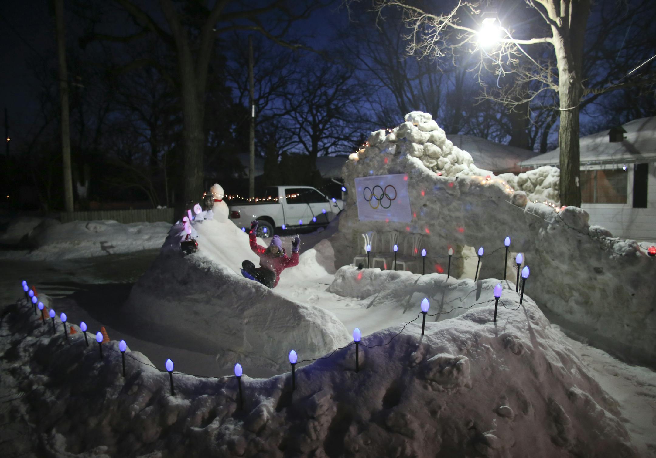 Tim Smith of Crystal built a miniature luge course in the front yard of his family's home. The frigid weather has kept is well preserved and an Olympic flag that arrived a day ago was the finishing touch. Savannah Smith, 12, took a run on her family's luge course Wednesday evening, January 22, 2014. ] JEFF WHEELER ‚Ä¢ jeff.wheeler@startribune.com