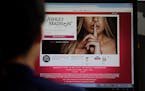 In this June 10, 2015 photo, Ashley Madison's Korean web site is shown on a computer screen in Seoul, South Korea. The Ashley Madison cheating website