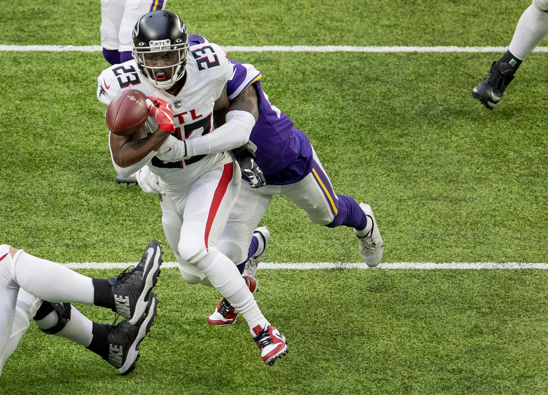 Minnesota Vikings Jeff Gladney (20) forced Atlanta Falcons running back Brian Hill (23) to fumble in the first quarter.