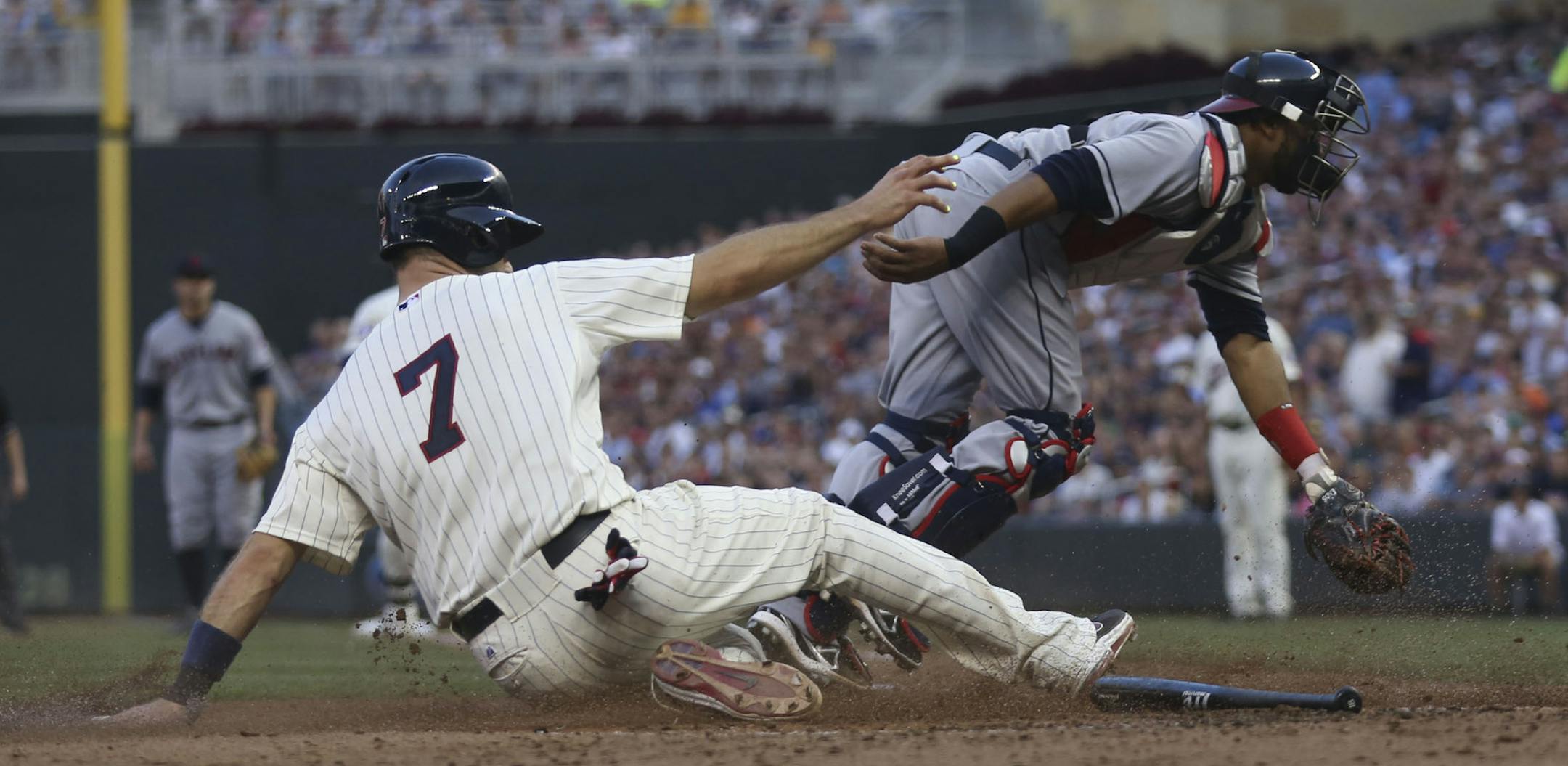 After a error throw from Cleveland Third baseman Lonnie Chisenhall, Twins Joe Mauer slid into home plate safely during the sixth inning at Target Field in Minneapolis Min., Saturday, July 20, 2013. ] (KYNDELL HARKNESS/STAR TRIBUNE) kyndell.harkness@startribune.com