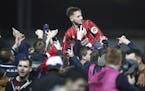 Bristol City's Josh Brownhill celebrates their victory as he is lifted up by fans after the final whistle in the English League Cup Quarter Final socc