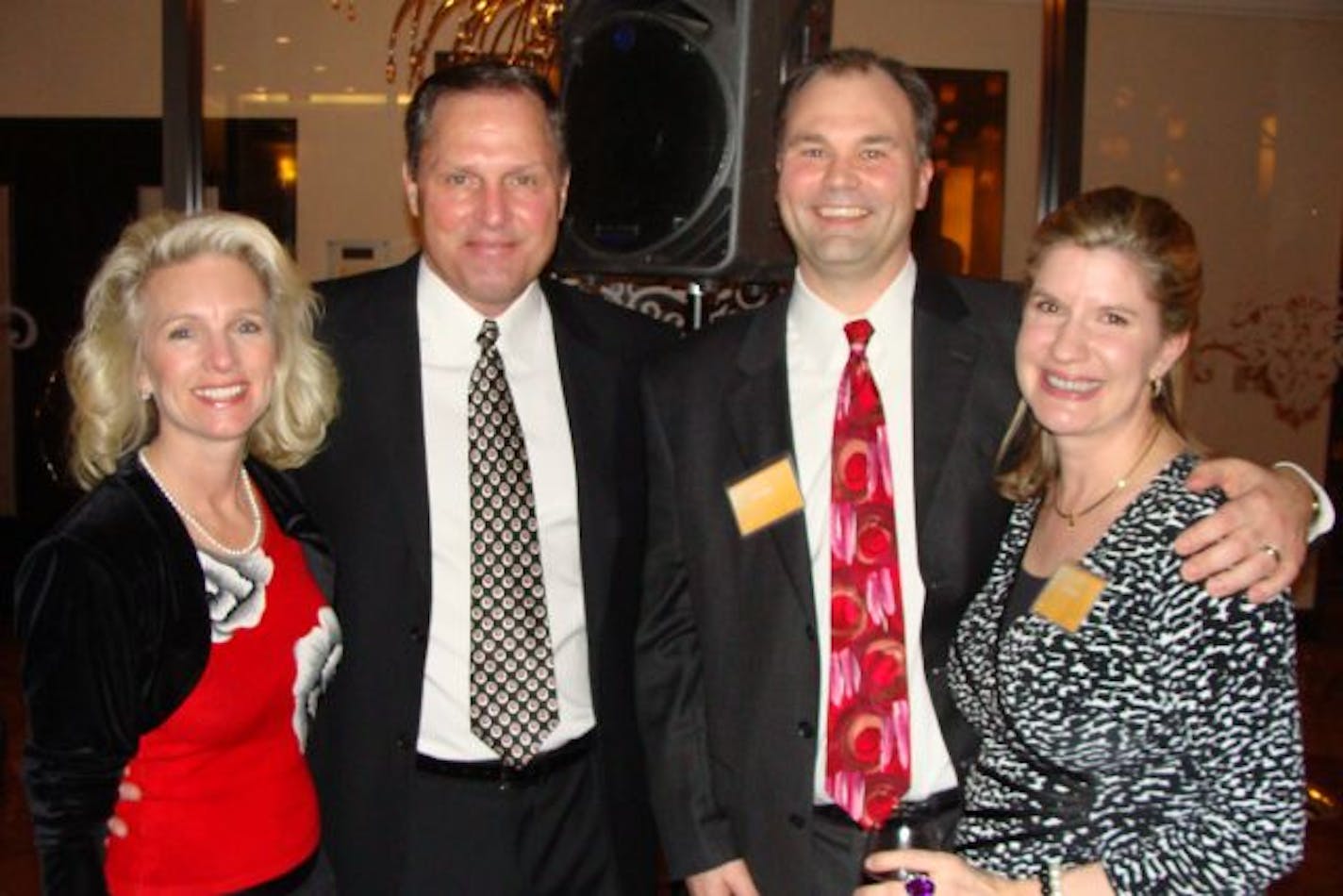 Cathy Brewster and Gophers football coach Tim Brewster, and Jon and Julie Olson