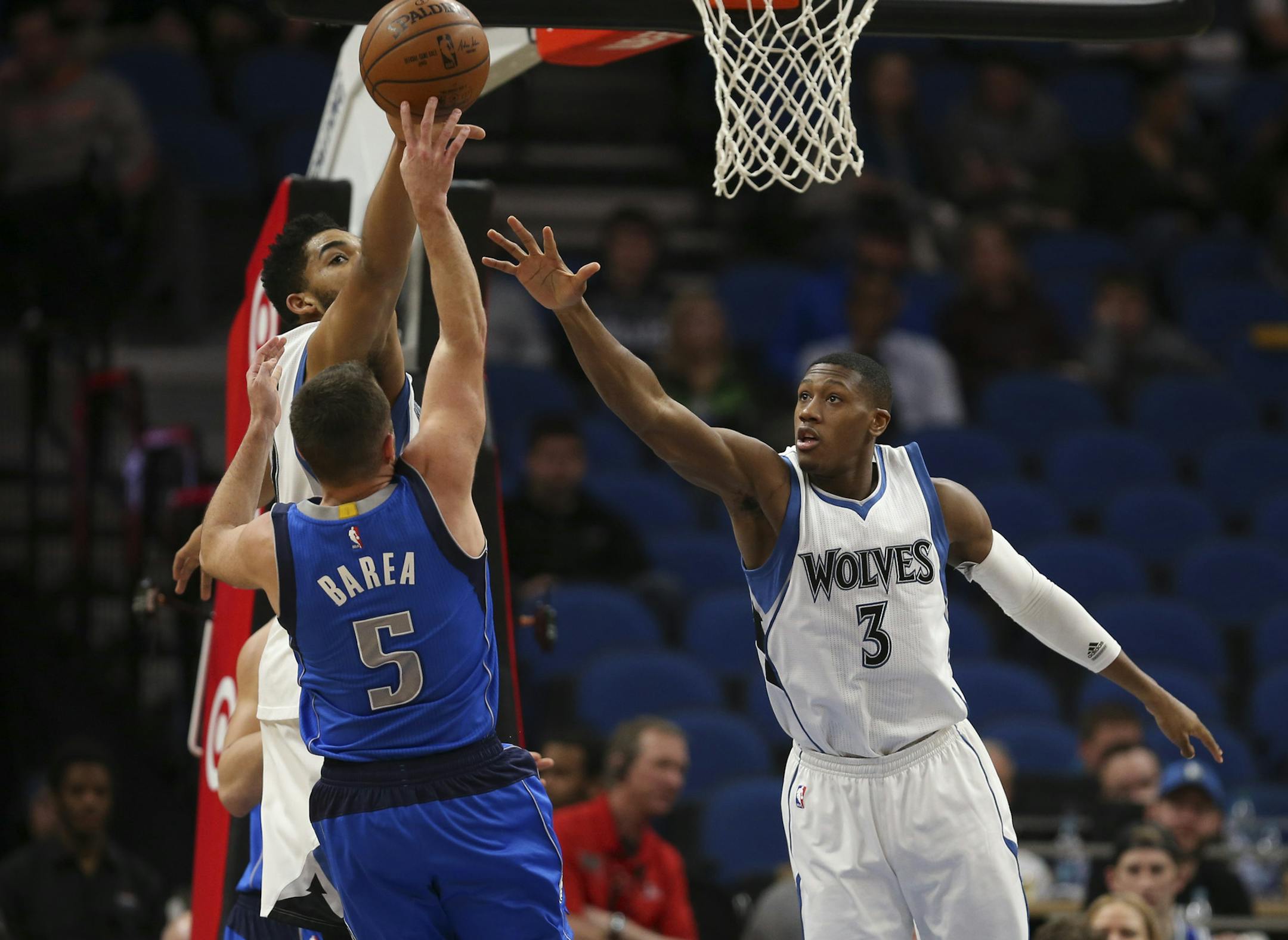 Minnesota Timberwolves center Karl-Anthony Towns (32) and Minnesota Timberwolves guard Kris Dunn (3) defended former Timberwolf, Dallas Mavericks guard J.J. Barea (5) as he shot in the first quarter. ] JEFF WHEELER &#xef; jeff.wheeler@startribune.com The Minnesota Timberwolves met the Dallas Mavericks in an NBA basketball game Monday night, January 9, 2017 at Target Center in Minneapolis.