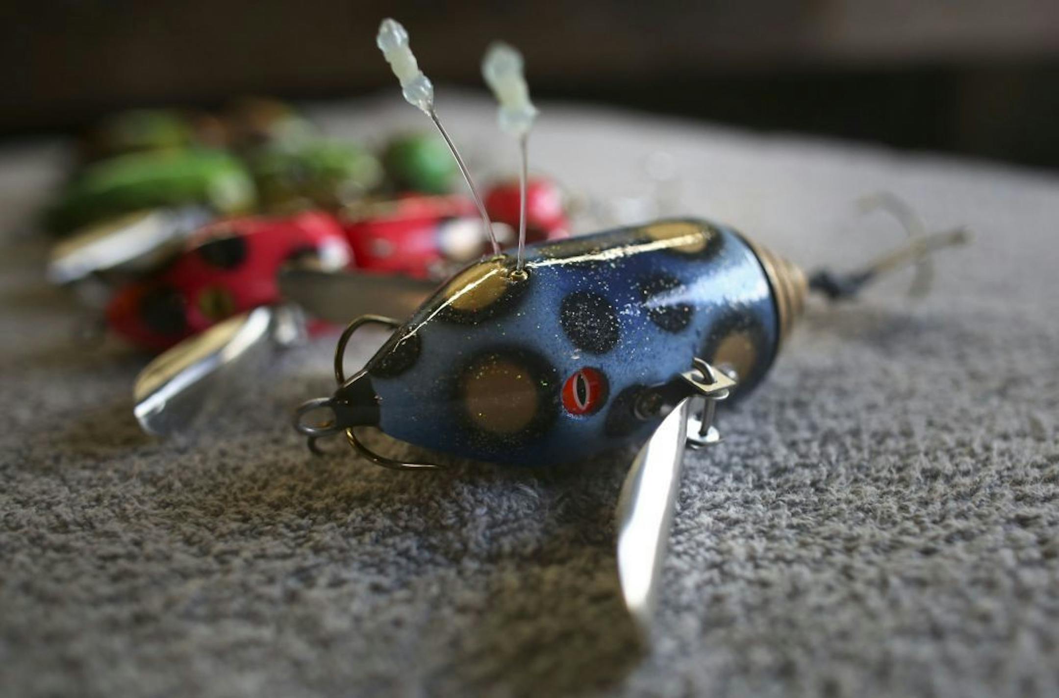 An alien surface bait along with other surface baits made by of Scott Kleinschmidt, of Musky Safari, in his basement workshop in Kenyon Minn.