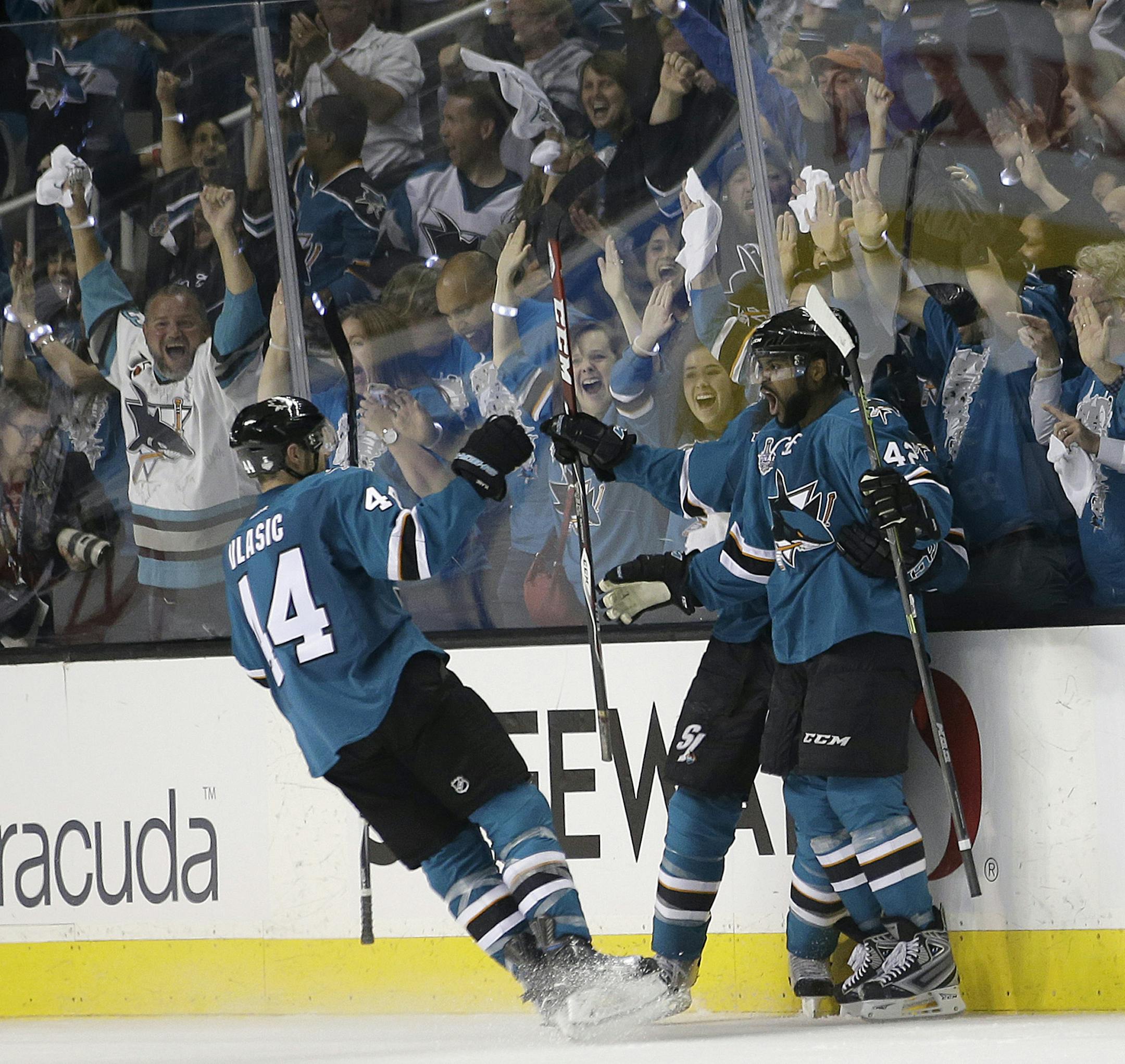 San Jose Sharks right wing Joel Ward, right, celebrates with teammates after scoring against the Pittsburgh Penguins during the third period of Game 3 of the NHL hockey Stanley Cup Finals in San Jose, Calif., Saturday, June 4, 2016. (AP Photo/Marcio Jose Sanchez)