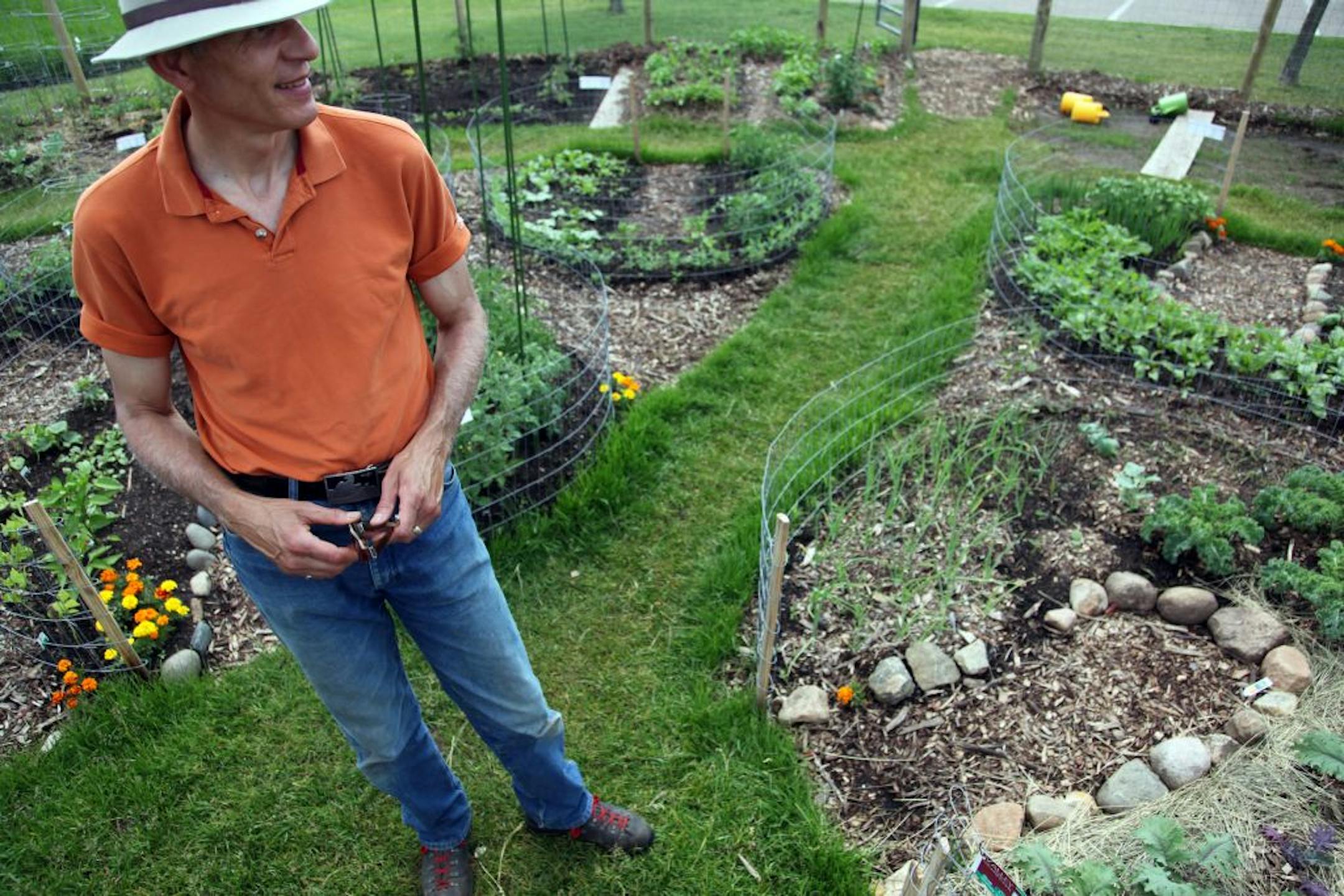 Gary Johnson, community relations director, walked through the community garden at Valley Natural Foods Co-op in Burnsville.