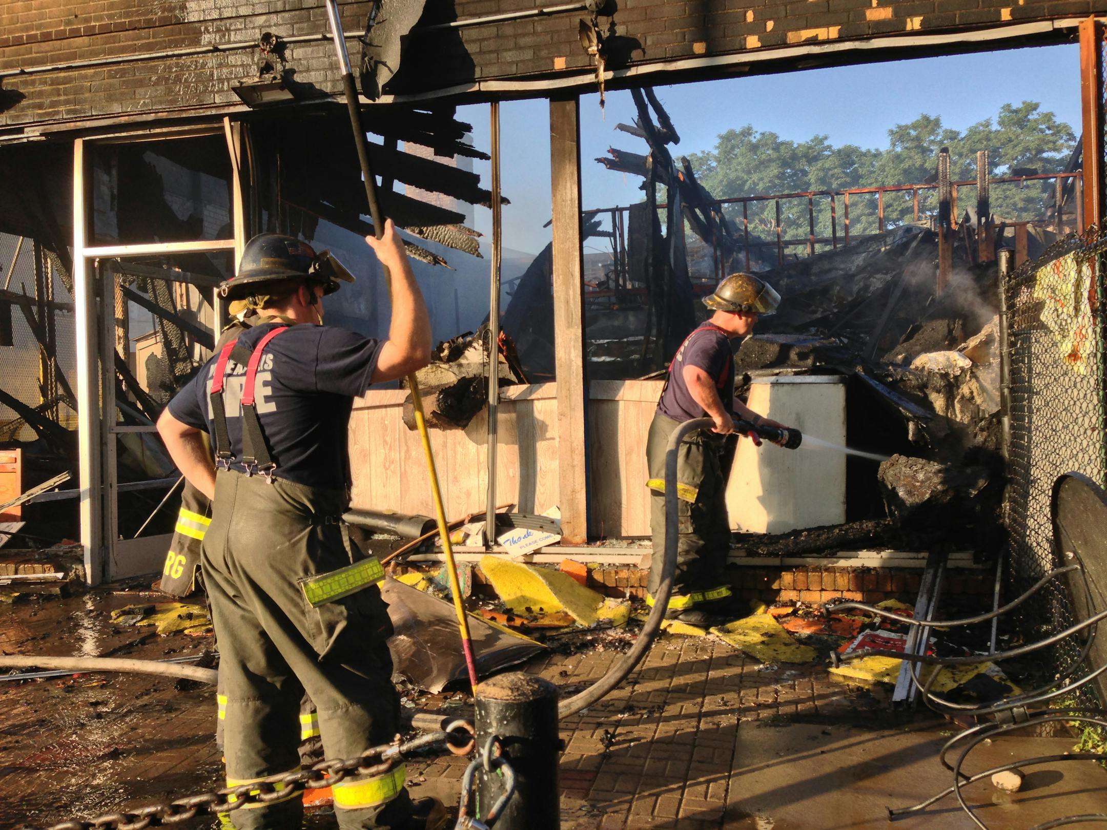 Early Thursday crews from the Minneapolis Fire Department worked to put out a fire that broke out late Wednesday in a commercial building near the University of Minnesota.The two-alarm fire caused extensive damage to the building which houses a child care, grocery market and an auto body shop.