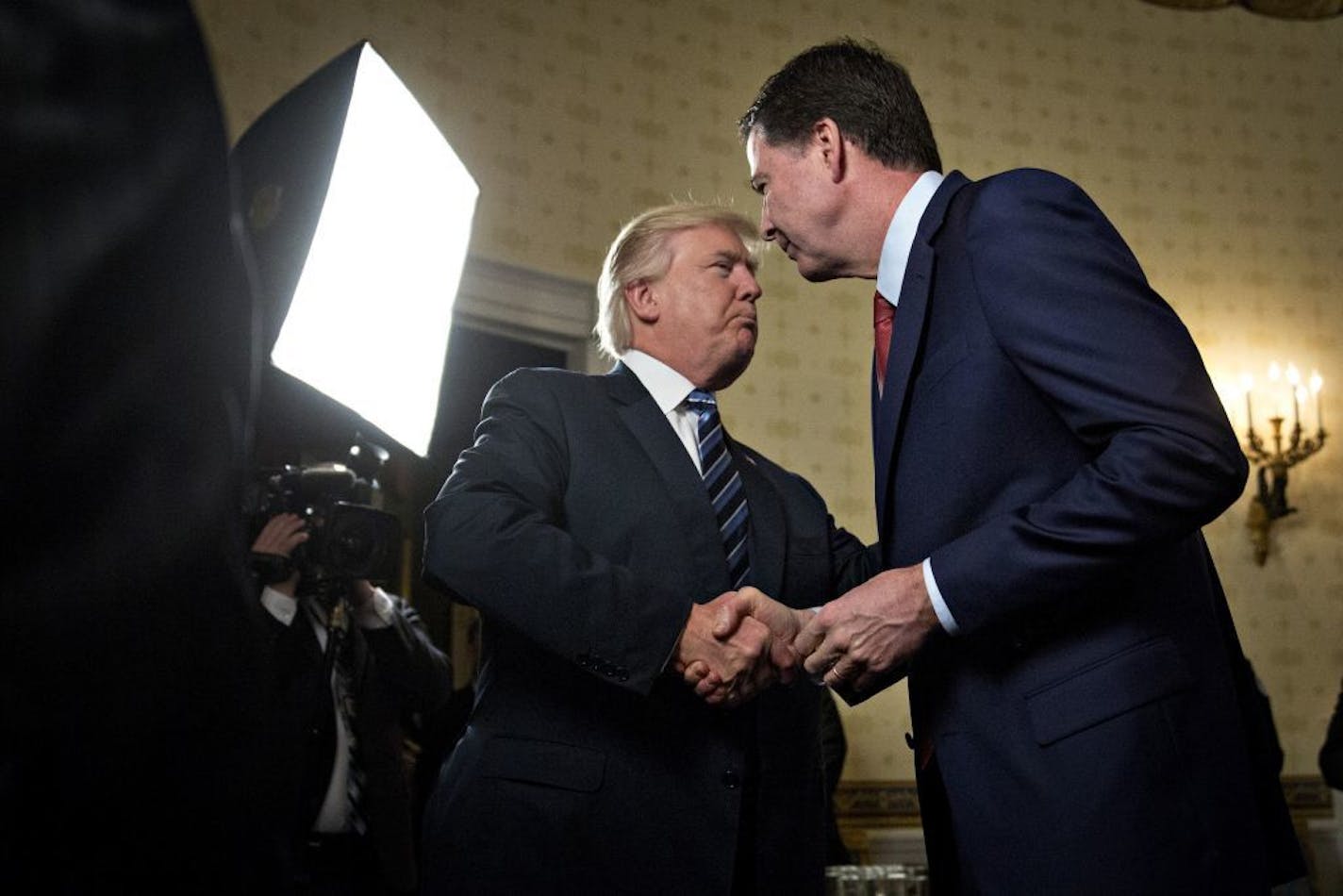 President Donald Trump, left, shakes hands with James Comey, then director of the Federal Bureau of Investigation, at the White House in January.