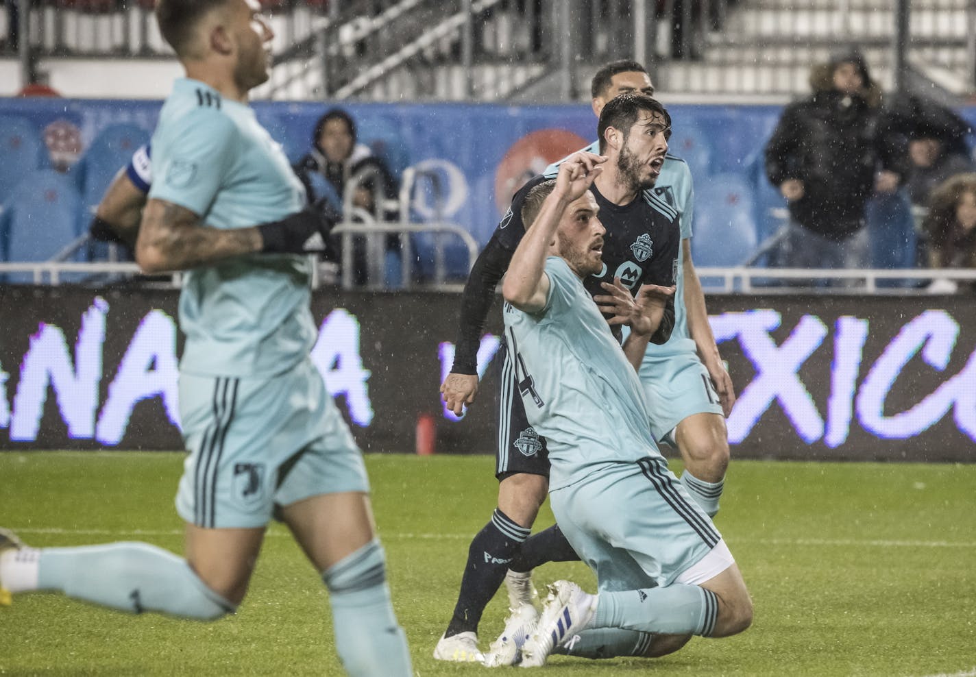 Toronto FC midfielder Alejandro Pozuelo (10) watches hits goal-attempt as Minnesota United's Eric Miller (4) defends during first-half MLS soccer match action in Toronto, Friday, April 19, 2019. (Christopher Katsarov/The Canadian Press via AP)