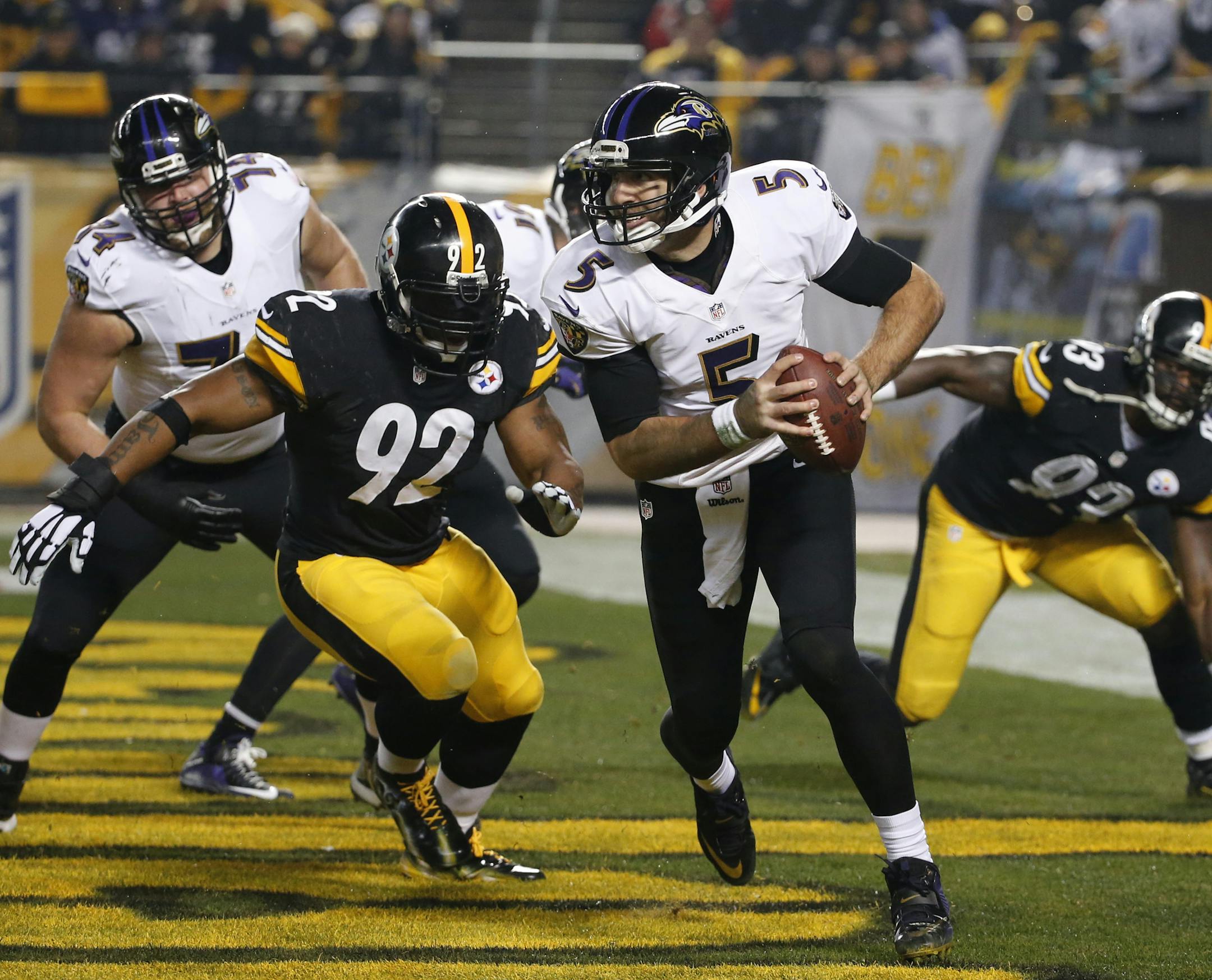 Baltimore Ravens quarterback Joe Flacco (5) is pressured by Pittsburgh Steelers outside linebacker James Harrison (92) in the first quarter an NFL wildcard playoff football game against the Baltimore Ravens, Saturday, Jan. 3, 2015, in Pittsburgh. (AP Photo/Gene J. Puskar)