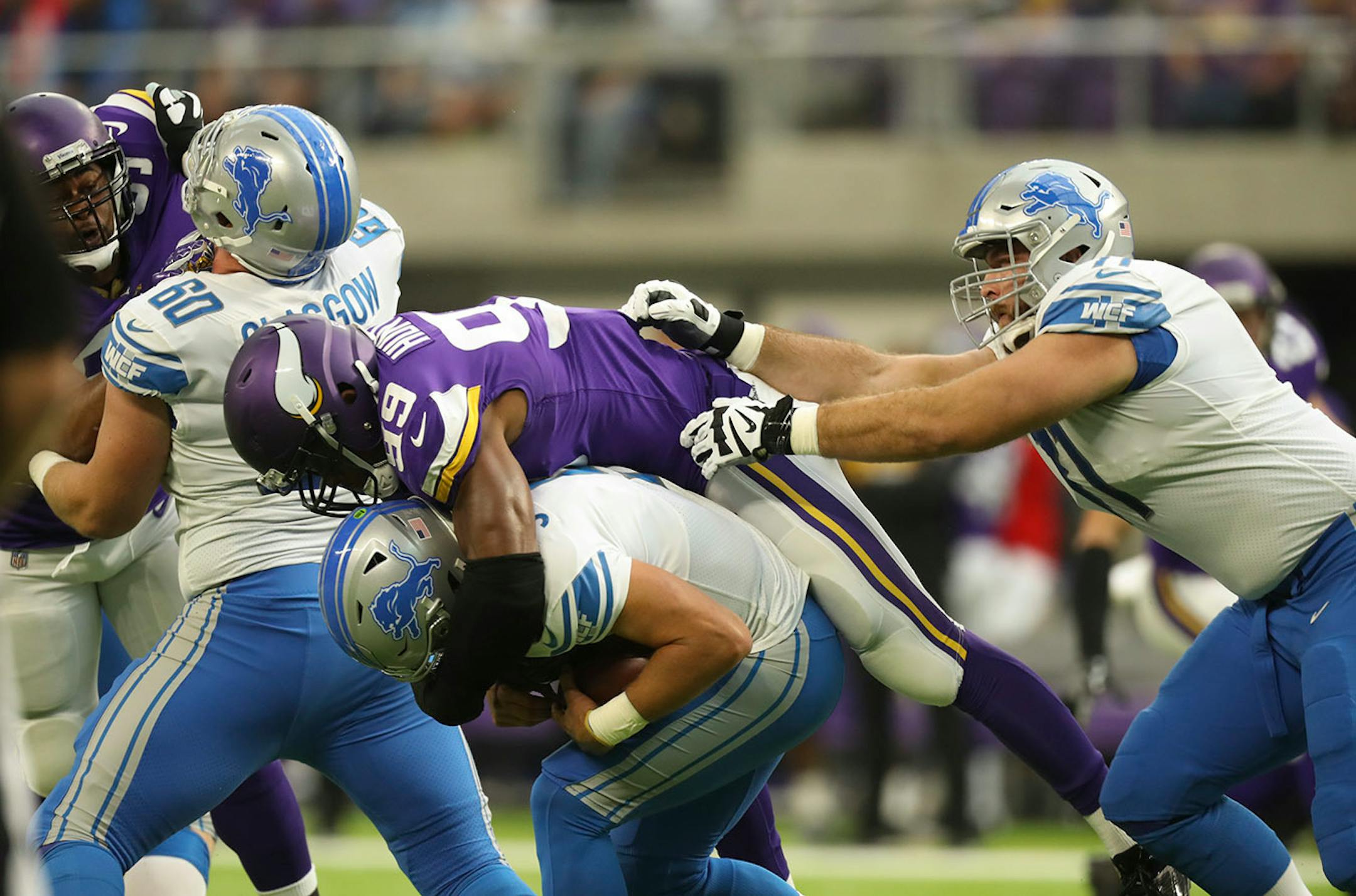 Detroit Lions quarterback Matthew Stafford (9) was sacked by Minnesota Vikings defensive end Danielle Hunter (99) for a five yard loss on the first play of the game.