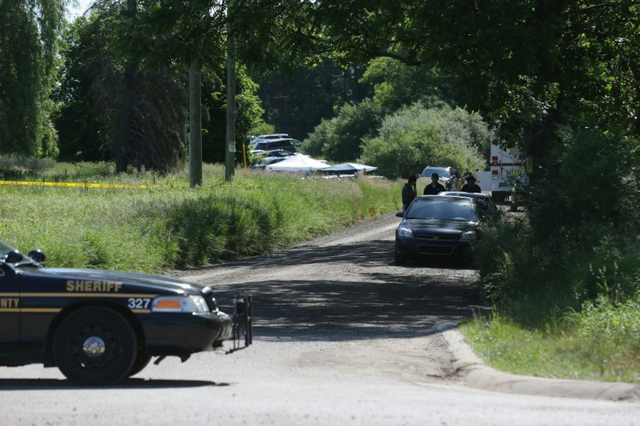 Law enforcement officials block the street to the scene in Oakland Township, Mich., Monday, June 17, 2013 where officials search for the remains of Teamsters union president Jimmy Hoffa who disappeared from a Detroit-area restaurant in 1975.