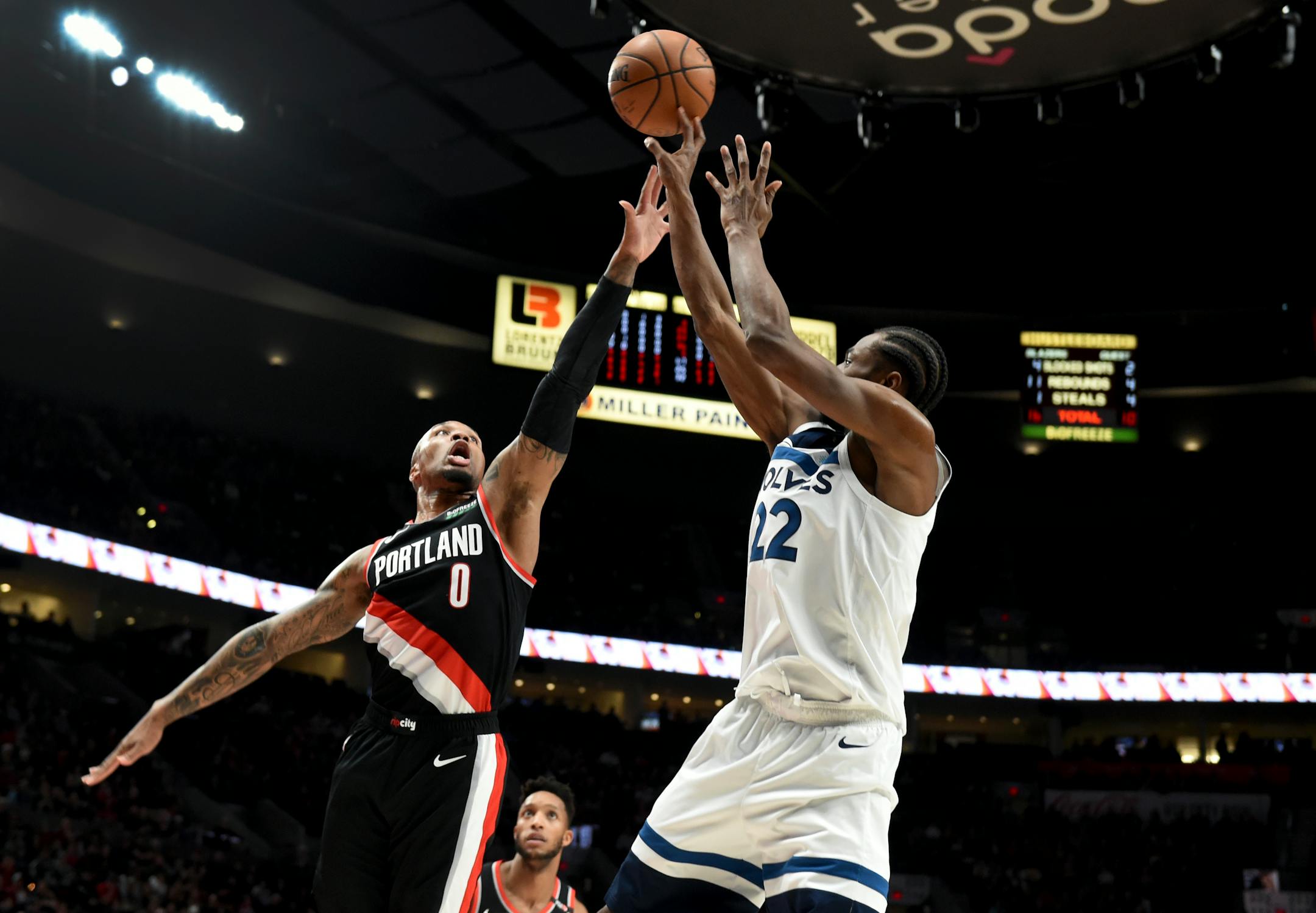 Minnesota Timberwolves forward Andrew Wiggins, right, shoots over Portland Trail Blazers guard Damian Lillard during the first half of an NBA basketball game in Portland, Ore., Saturday, Dec. 8, 2018. (AP Photo/Steve Dykes)