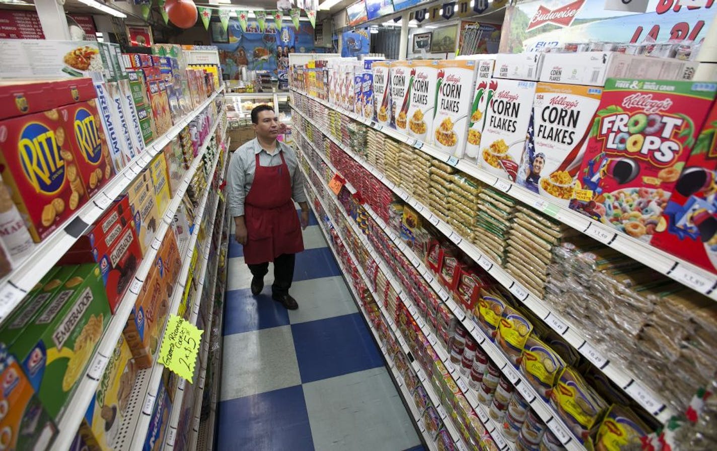 In this photo taken Thursday, Nov. 1, 2012, Grocery market owner Ray Martinez poses for a photo at La Playa Market in Inglewood, Calif. Martinez opposes the passing of California Proposition 37, Mandatory Labeling of Genetically Engineered Food. For every unmarked item at his Inglewood store, Martinez would need to get a sworn statement from suppliers or get independent certification confirming products are GMO-free.