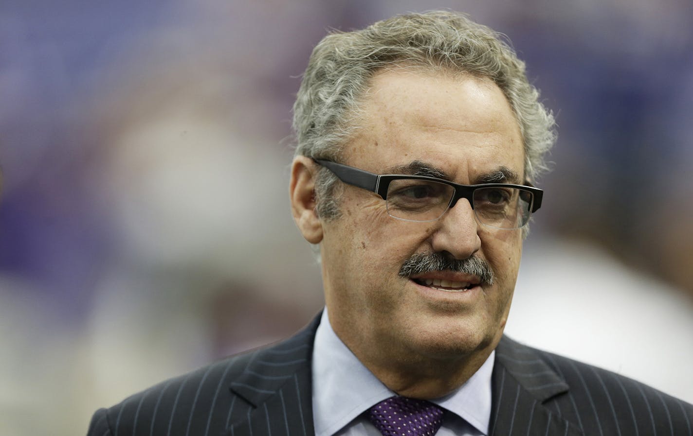 Minnesota Vikings owner Zygi Wilf waits on the field before an NFL football game between the Vikings and the Cleveland Browns Sunday, Sept. 22, 2013, in Minneapolis. (AP Photo/Charlie Neibergall) ORG XMIT: MIN2013092614562874