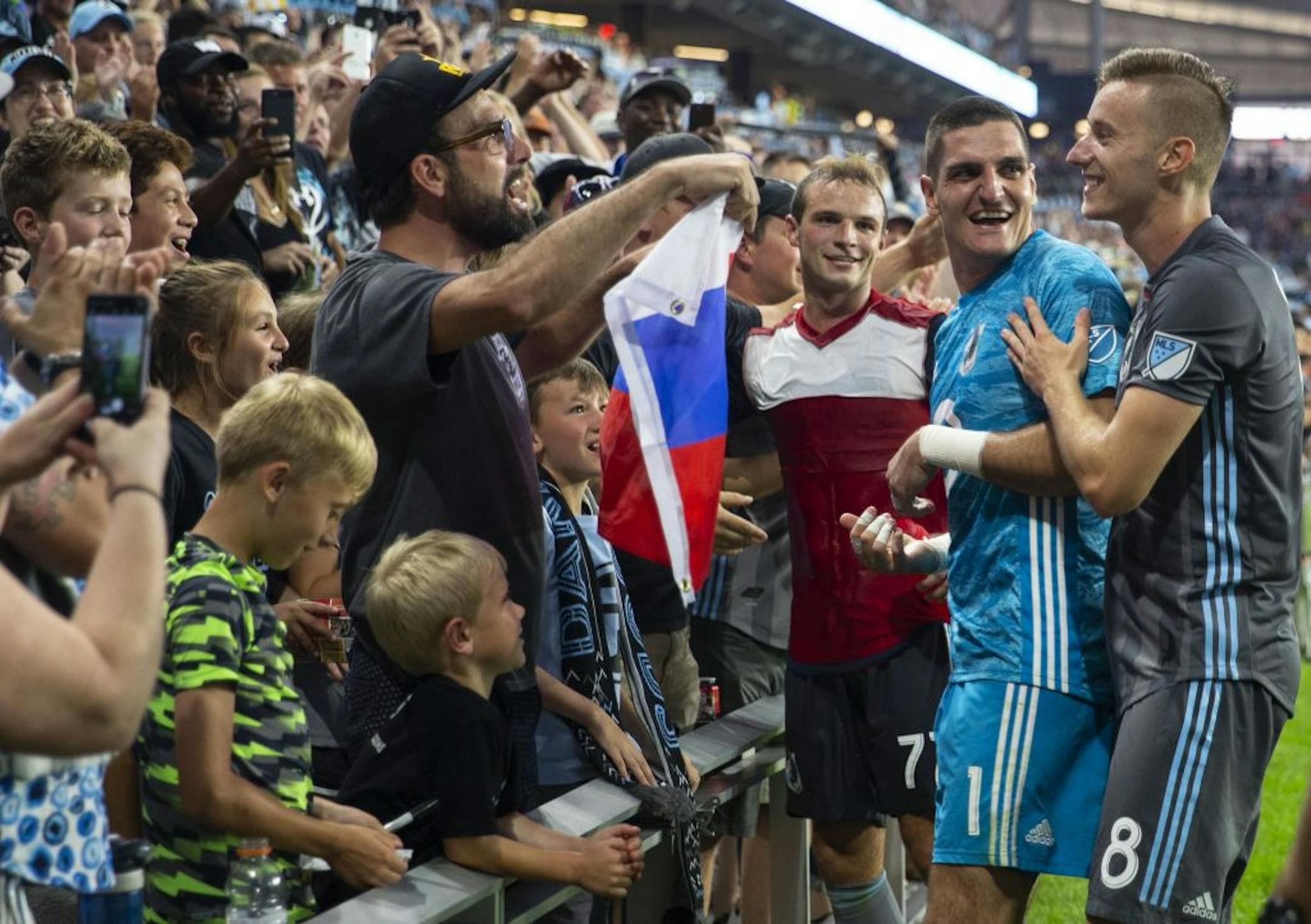 Vito Mannone (1) and Jan Gergus (8) celebrate with family and fans on the sideline after the game. ALEX KORMANN ¥ alex.kormann@startribune.com The Minnesota United FC took on FC Dalls on Saturday July 13, 2019 at Allianz Field in St. Paul, MN.