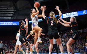 Goodhue guard Elisabeth Gadient takes a shot over Underwood forward Mily Albjerg (2). Gadient finished with 22 points and 11 rebounds.