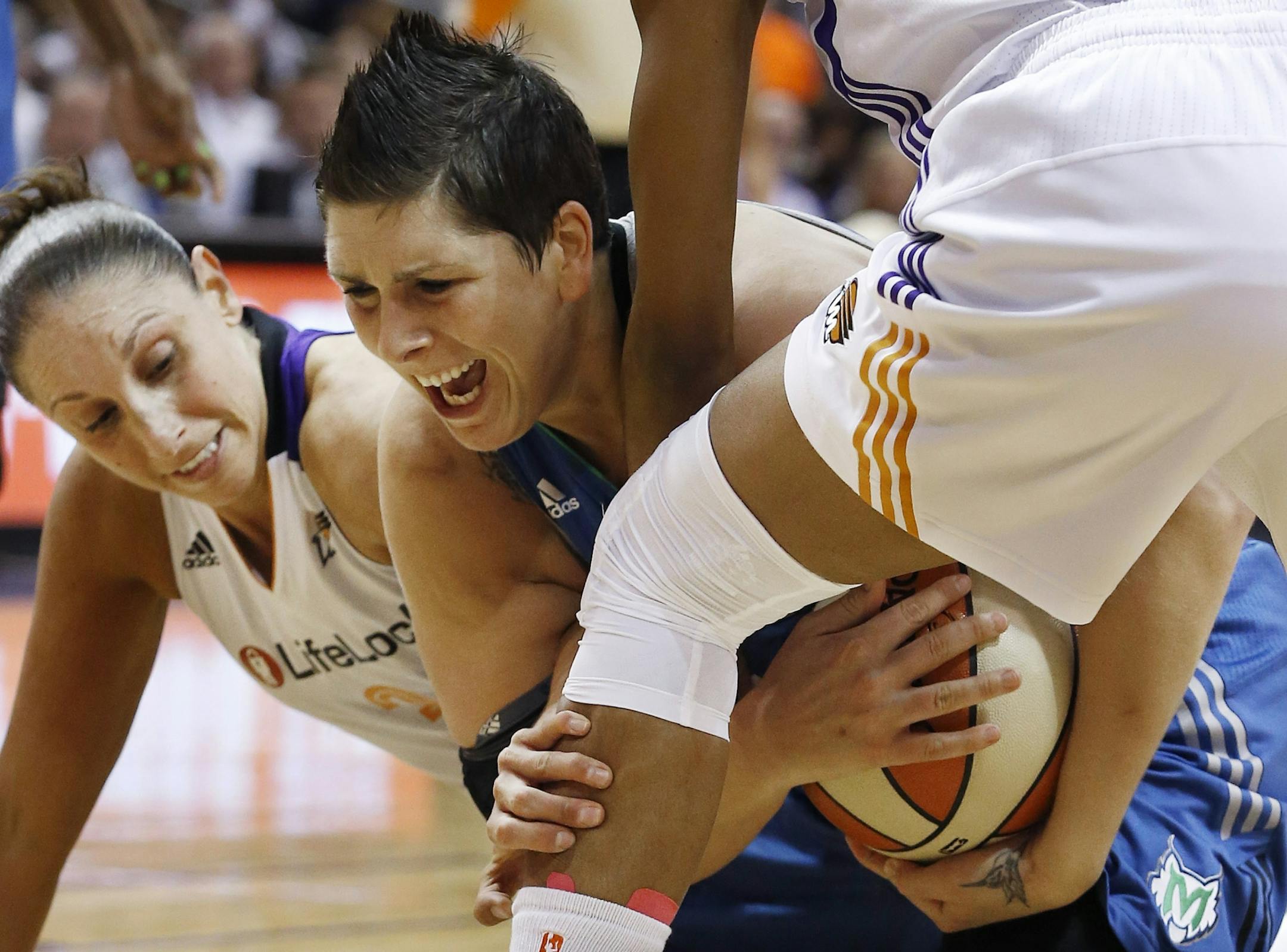 Phoenix Mercury's Diana Taurasi, left, and Briana Gilbreath, right, force a jump ball as Minnesota Lynx's Janel McCarville, center, tries to hang on to the ball during the first half in a WNBA Western Conference Finals basketball game on Sunday, Sept. 29, 2013, in Phoenix.