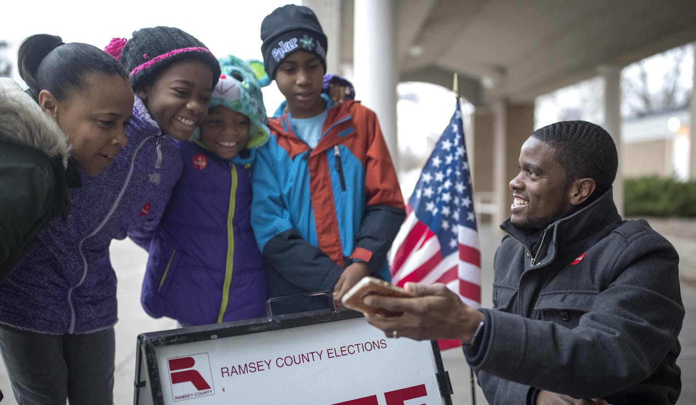 Prior to winning election as St. Paul mayor, Melvin Carter, his wife Sakeena, and their children, from left, Maylena, 11, Naomi, 9, and Myles, 10, took a selfie in front of a vote here sign on Nov. 7 in St. Paul.