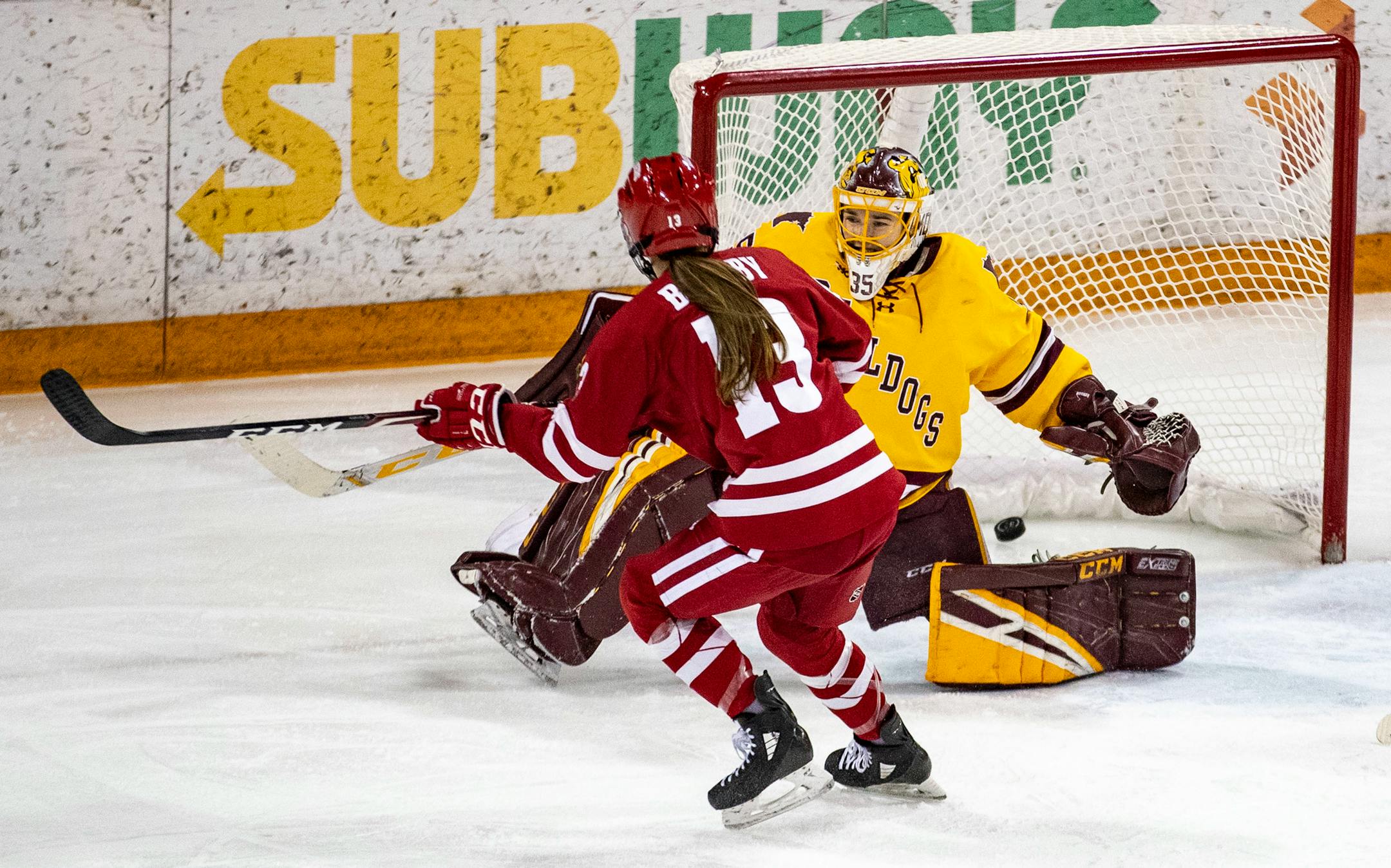 Wisconsin left defender Grace Bowlby (13) scored on University of Minnesota Duluth goaltender Maddie Rooney (35) on a power play in the second period to give Wisconsin a 2-1 lead. ]