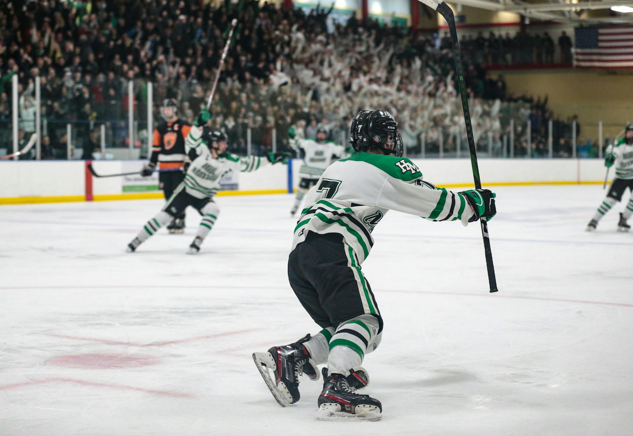Hill-Murray's Nick Pierre (7) celebrates his game-winning goal and heads down the ice to celebrate with teammates. Pierre's third period goal gave the Pioneers a 3-2 win over White Bear Lake. Photo by Cheryl A. Myers, SportsEngine