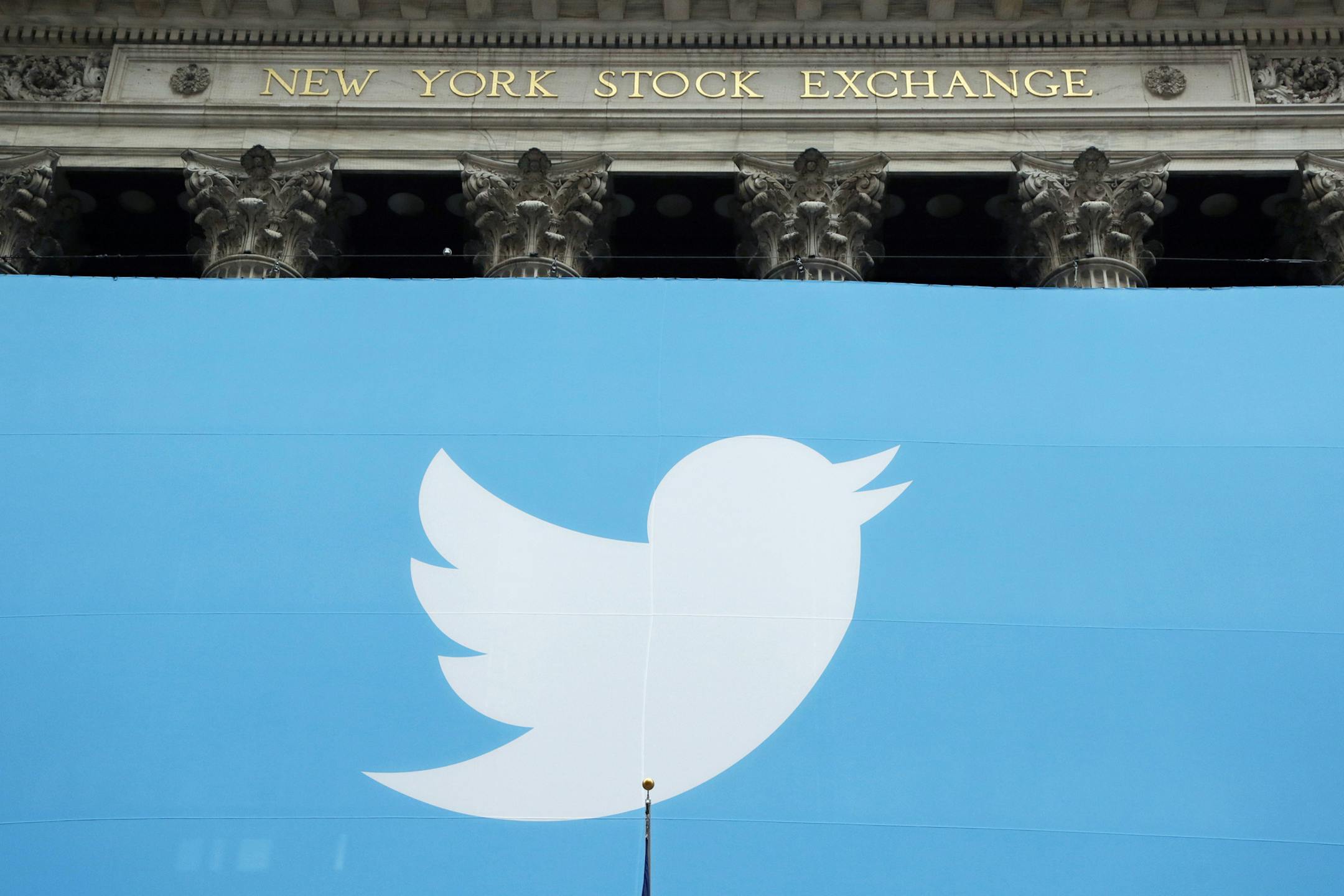 FILE- In this Nov. 7, 2013, file photo, a Twitter sign is draped on the facade of the New York Stock Exchange before its IPO in New York. Twitter reports financial results Thursday, Feb. 7, 2019. (AP Photo/Mark Lennihan, File)
